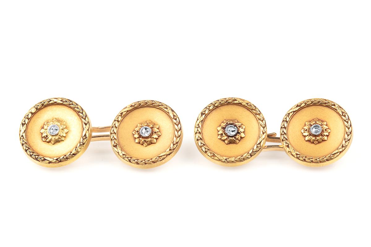A fine colour dress set in 18 karat yellow gold with a pair of double sided cufflinks and four matching studs. The central rose cut diamond has a carved floral surround bordered with a leaf design. The soft colour of the patina is excellent and is