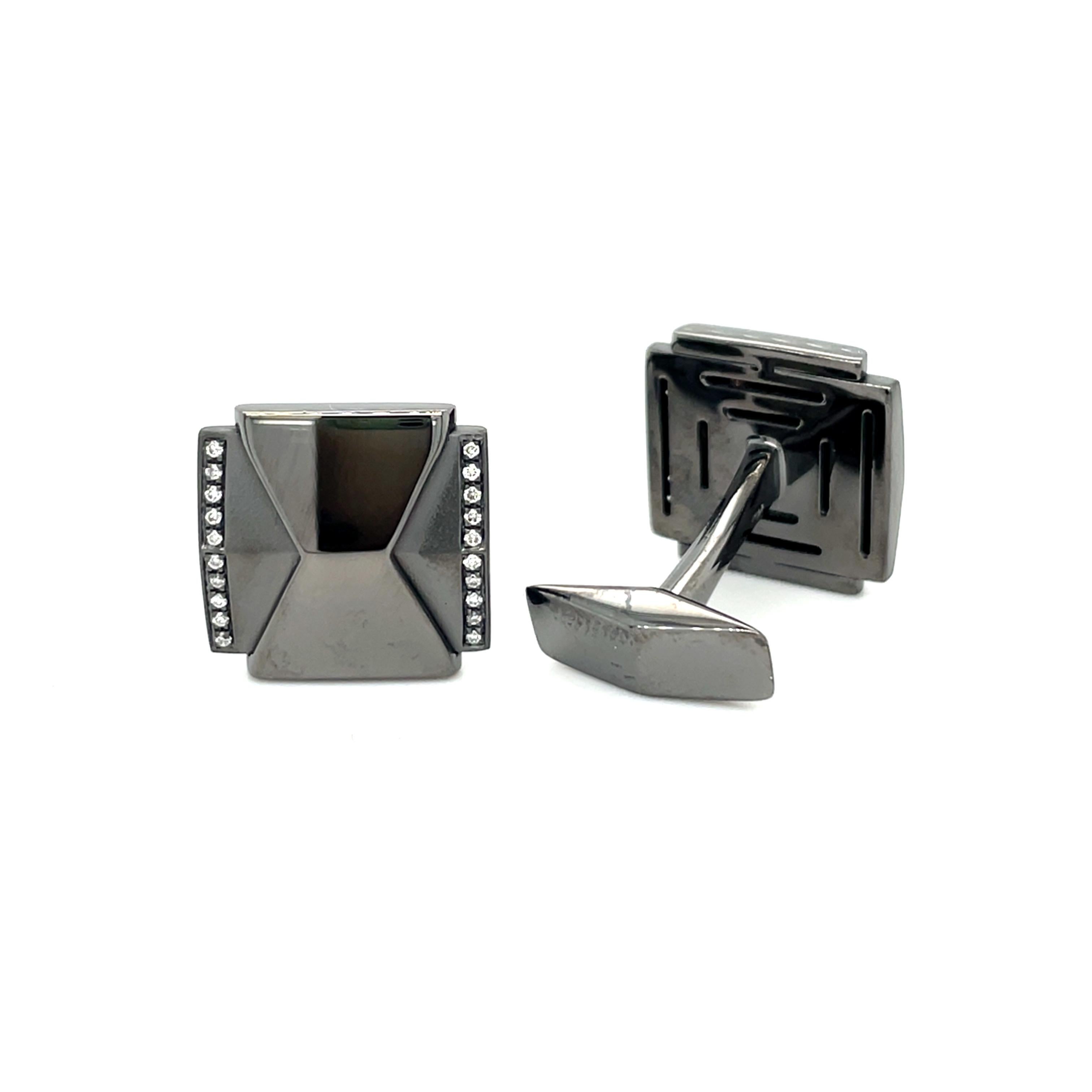 These white gold (black rhodium) cufflinks are from Men's Collection. These cufflinks are decorated with diamonds G color VS clarity. The total amount of it is 0.12 Carat. The dimensions of the cufflinks are 1.8cm x 1.5cm. These cufflinks are a