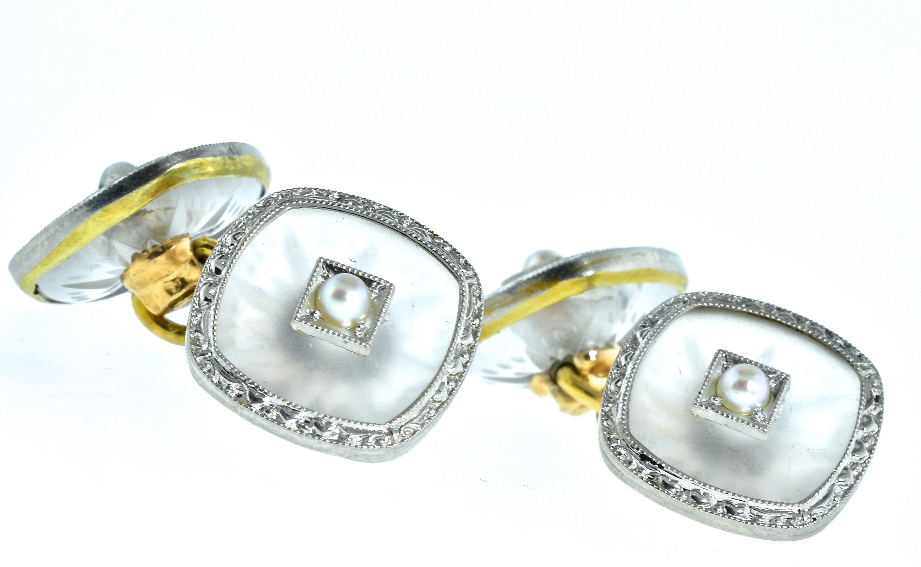 Art Deco cufflinks, circa 1930, centering a small seed pearl set in the frosted Rock Crystal and rimmed in both white and yellow gold with an etched design in the white gold.  These back to back cufflink are in fine condition.  The face of each is