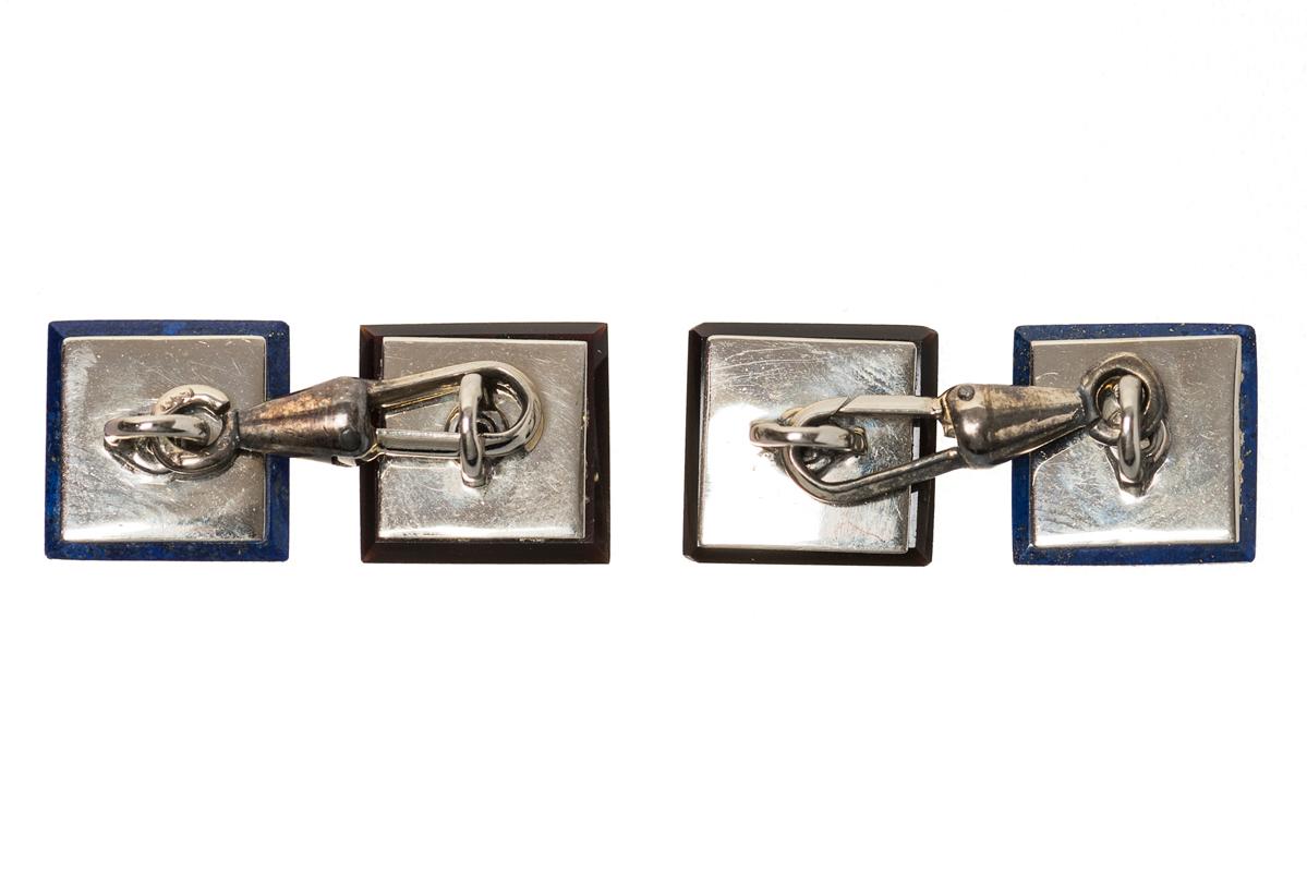 Vintage pair of double sided square cufflinks in frosted platinum with central old cut brilliant diamond. One face has a surround of onyx with the other in lapis lazuli. Original connecting link and fitted in their original case. Austrian