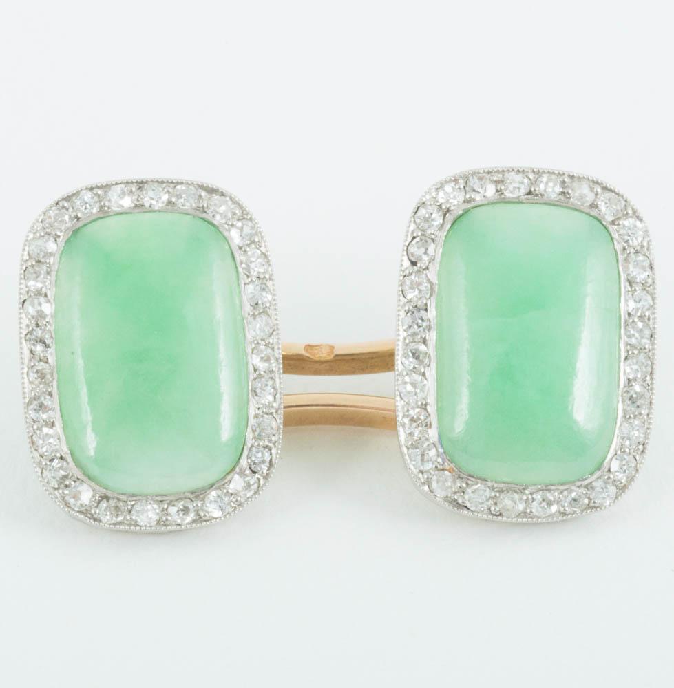 Pair of oval platinum mounted cufflinks with an attractive jade centre,very well matched,with a surround of brilliant cut diamonds. French circa 1920