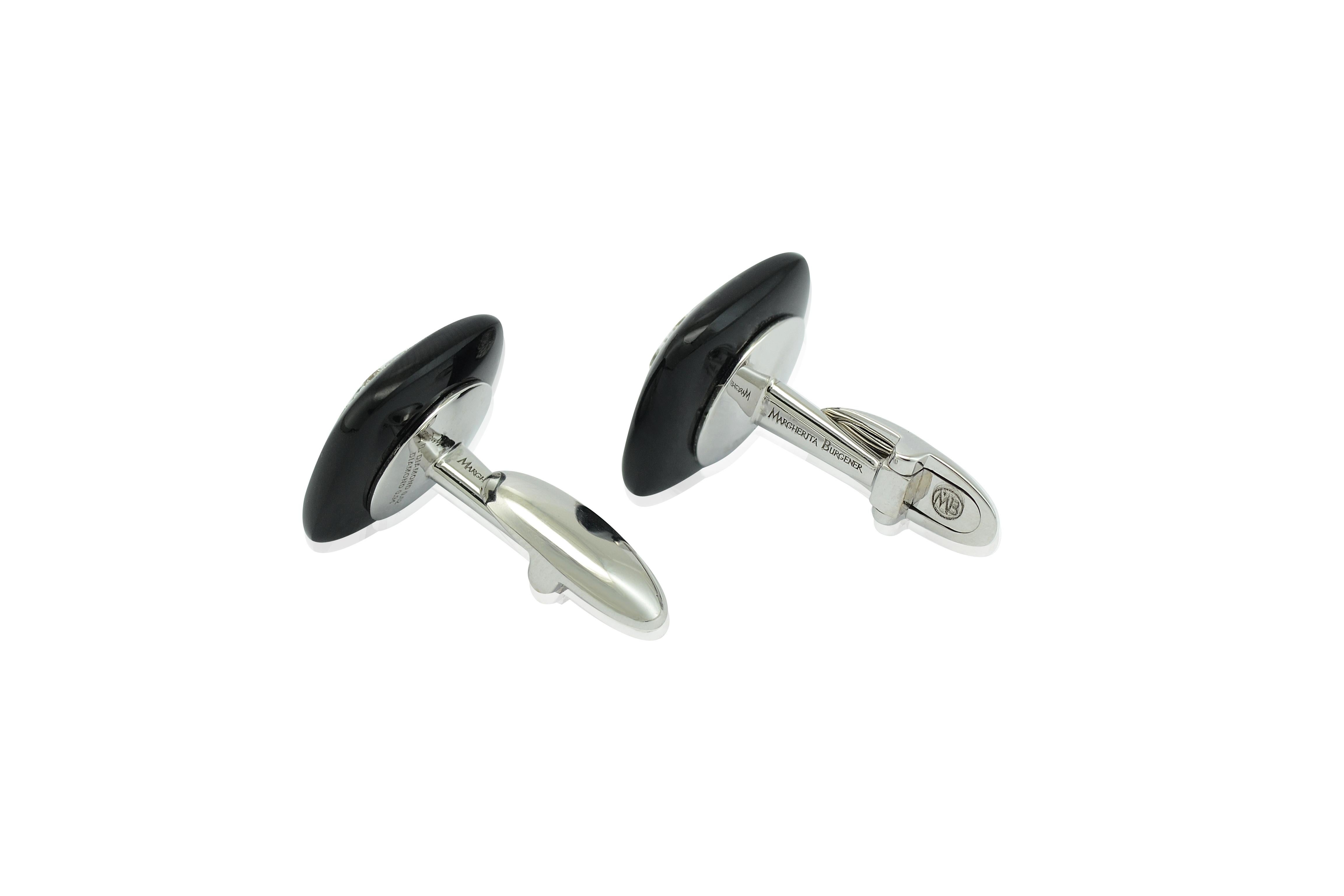 Handcrafted in Italy in Margherita Burgener workshop, the lovely pair of onyx cufflinks features  at the center a round black diamond and 8 white diamonds all around, set in white gold
The onyx measures 0.59 by 0.59 inches.
T bar is palne gold. you