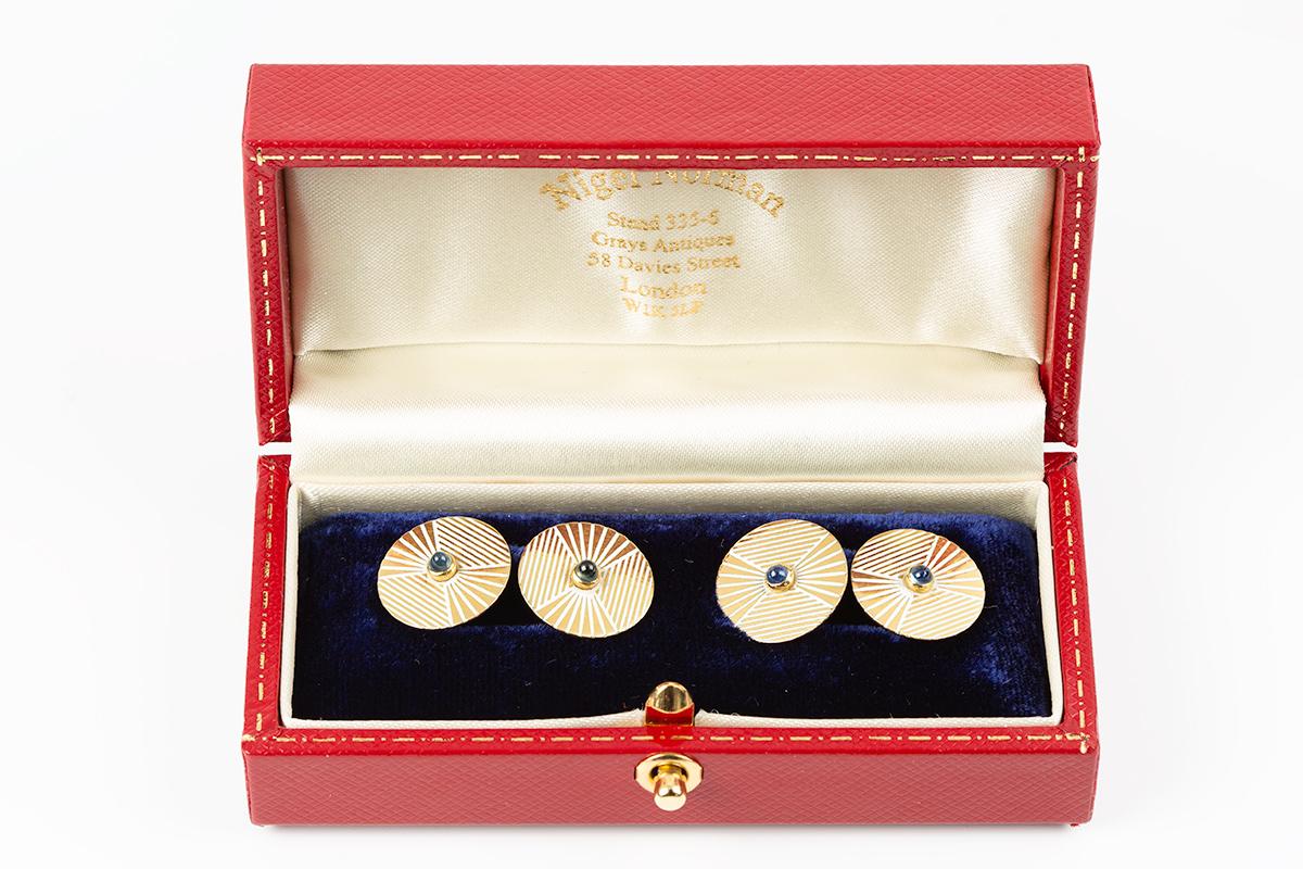 A good quality pair of double sided circular cufflinks with a cabochon cut sapphire centre ,surrounded with white enamel of unusual design, mounted on 18 karat gold. French marked with the Eagles head, measures 15 mm across
An attractive pair of