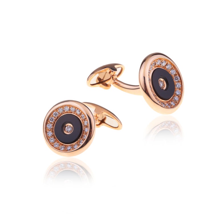 Cufflinks Round 18kt Gold with Onyx and Diamonds.
Cufflinks for Men for Business or Leisure Time to be worn preferably on White Elegant Shirt Cuff  but even Shirts with stripe.  
The circle of onyx is set on gold with a circle of diamonds and a