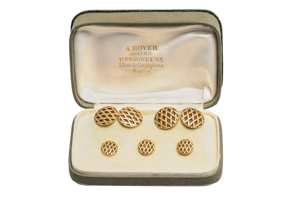 A heavy quality set of antique double sided cufflinks and three studs in 18 karat yellow gold. Circular in shape with a criss cross design and inset bronze enamel. Good colour and weight with French marks (Brevette) to the rings and connecting link.