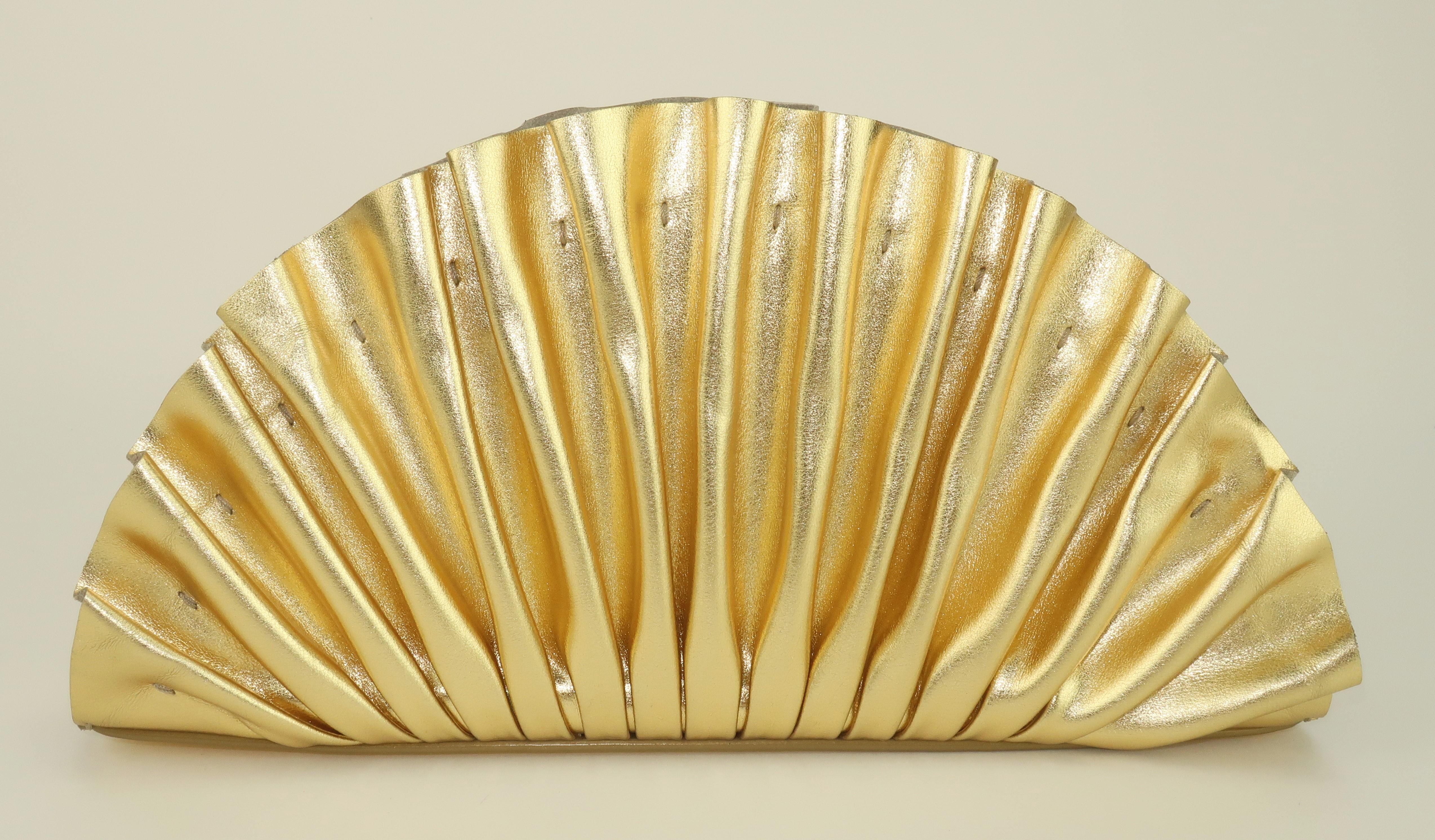 Get the gold!  Cult Gaia creates a lovely Art Deco inspired gold leather clutch handbag in the ultra feminine shape of a fan.  Beautifully detailed, the Nala Mini Clutch includes pleated folds and exposed stitching, all in sumptuous high quality