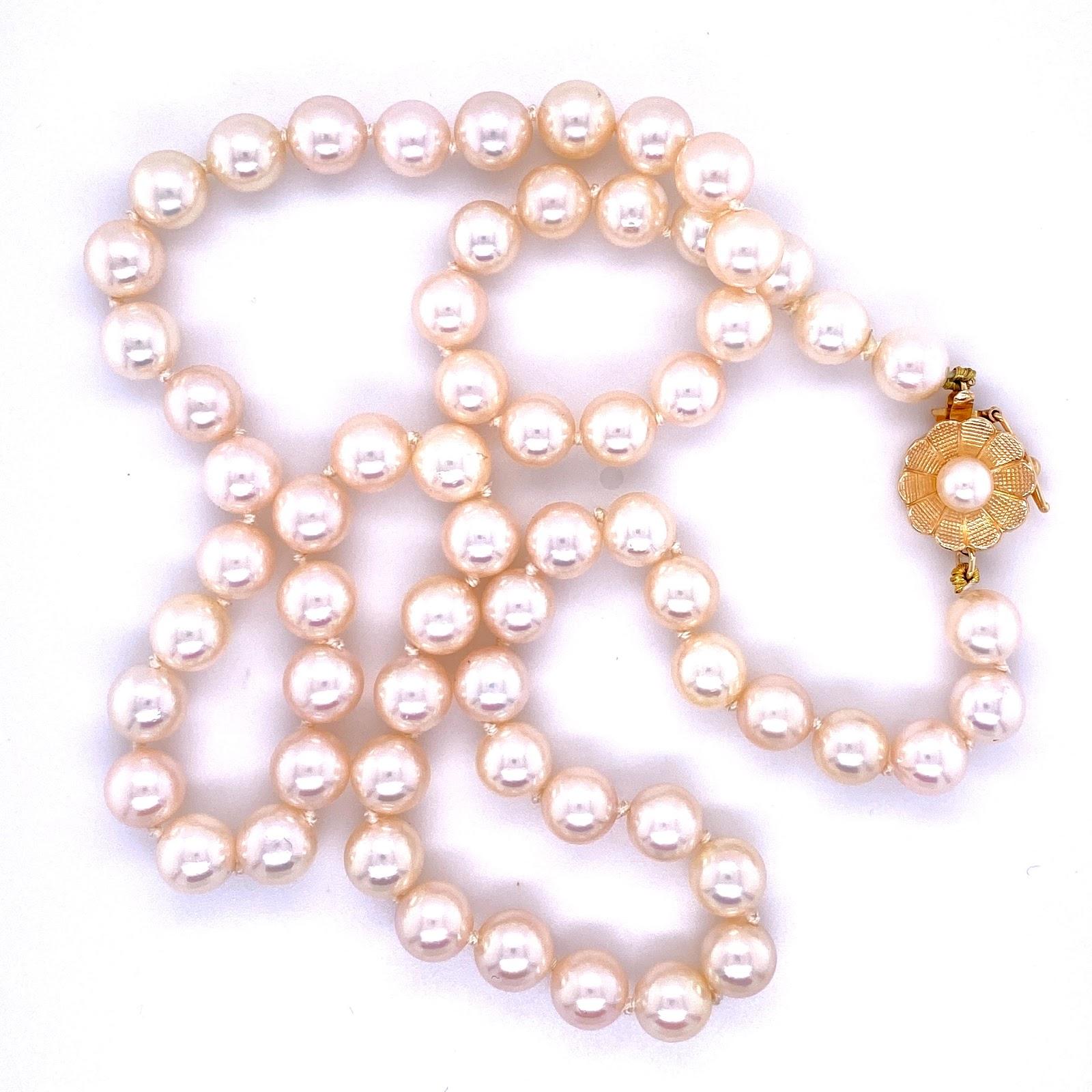 14 karat yellow gold floral clasp with florentine finish with a 11 mm diameter box clasp with figure 8 safety. The pears are 6 - 6.5 mm cultured akoya pearls strung with knots to 18’’. The strand contains 63 pearls plus one in the clasp. 