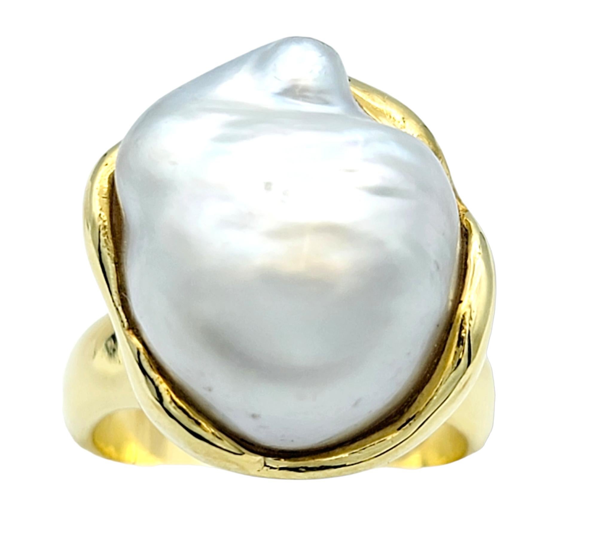Ring size: 5.75

The opulent fusion of an extraordinary cultured baroque freshwater pearl ensconced within an exquisite 18 karat gold ring conjures an unparalleled work of fine jewelry. The 18 karat gold brings a lustrous brilliance to this piece