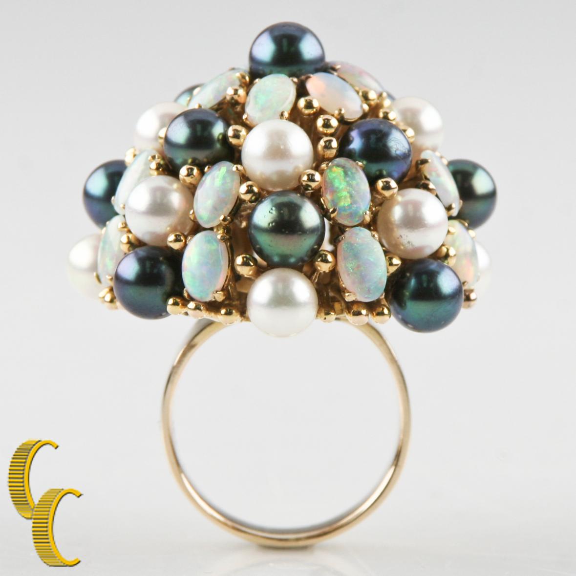 18KT yellow gold ring with a bright polish finish
Condition is good.
Ladies 18KT Yellow Gold Cultured Freshwater Pearl and Opal Ring
Size 8 1/2
The ring features a tapering bouquet of cultured freshwater pearls and opals supported by an elaborate