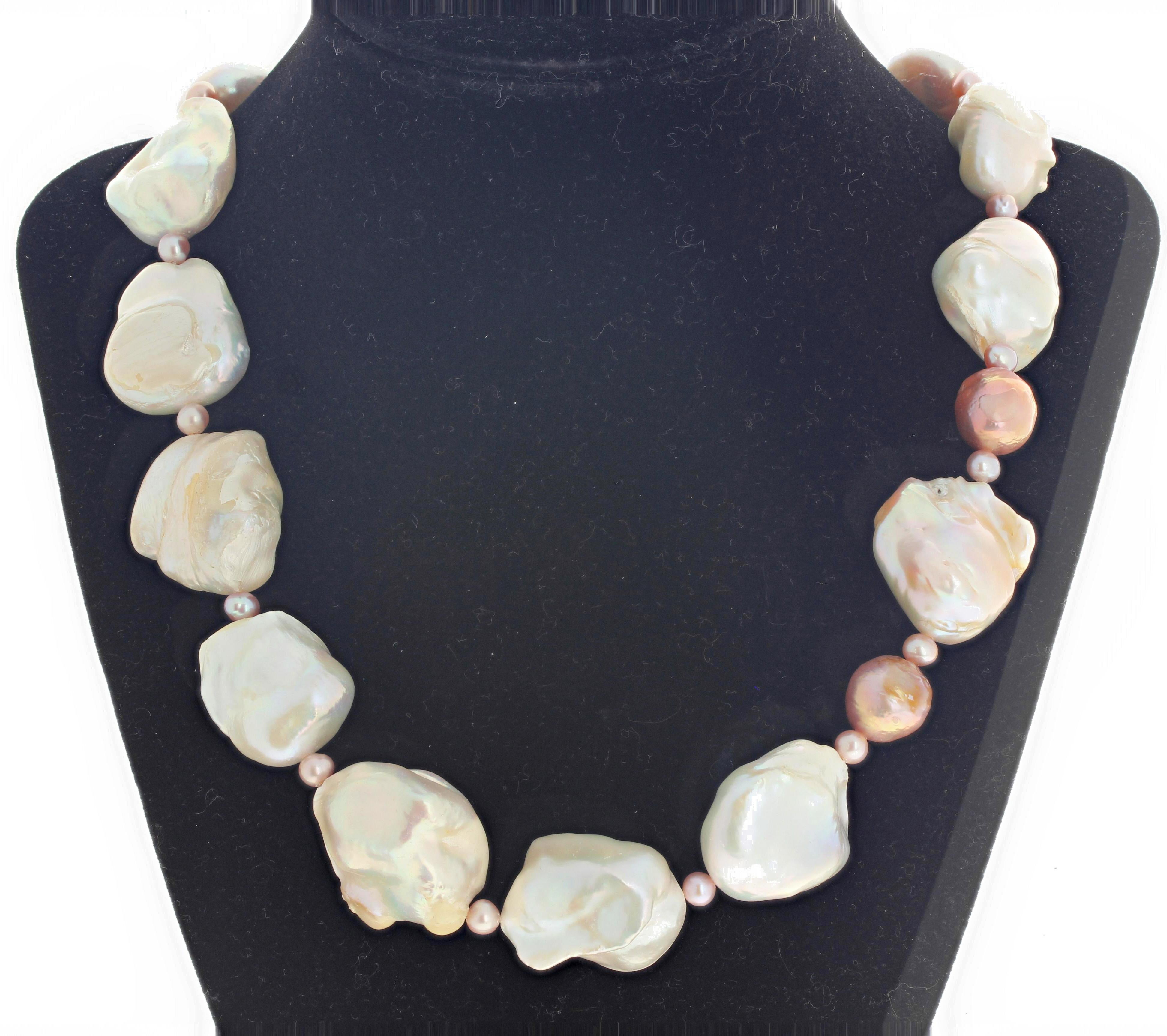 Beautiful elegant freshwater cultured Pearls (the largest is approximately 25 mm x 25 mm) reflect elegantly with the natural cultured pinky Pearls set sideways down the necklace for a more dramatic effect.  This necklace is 22 inches long and the