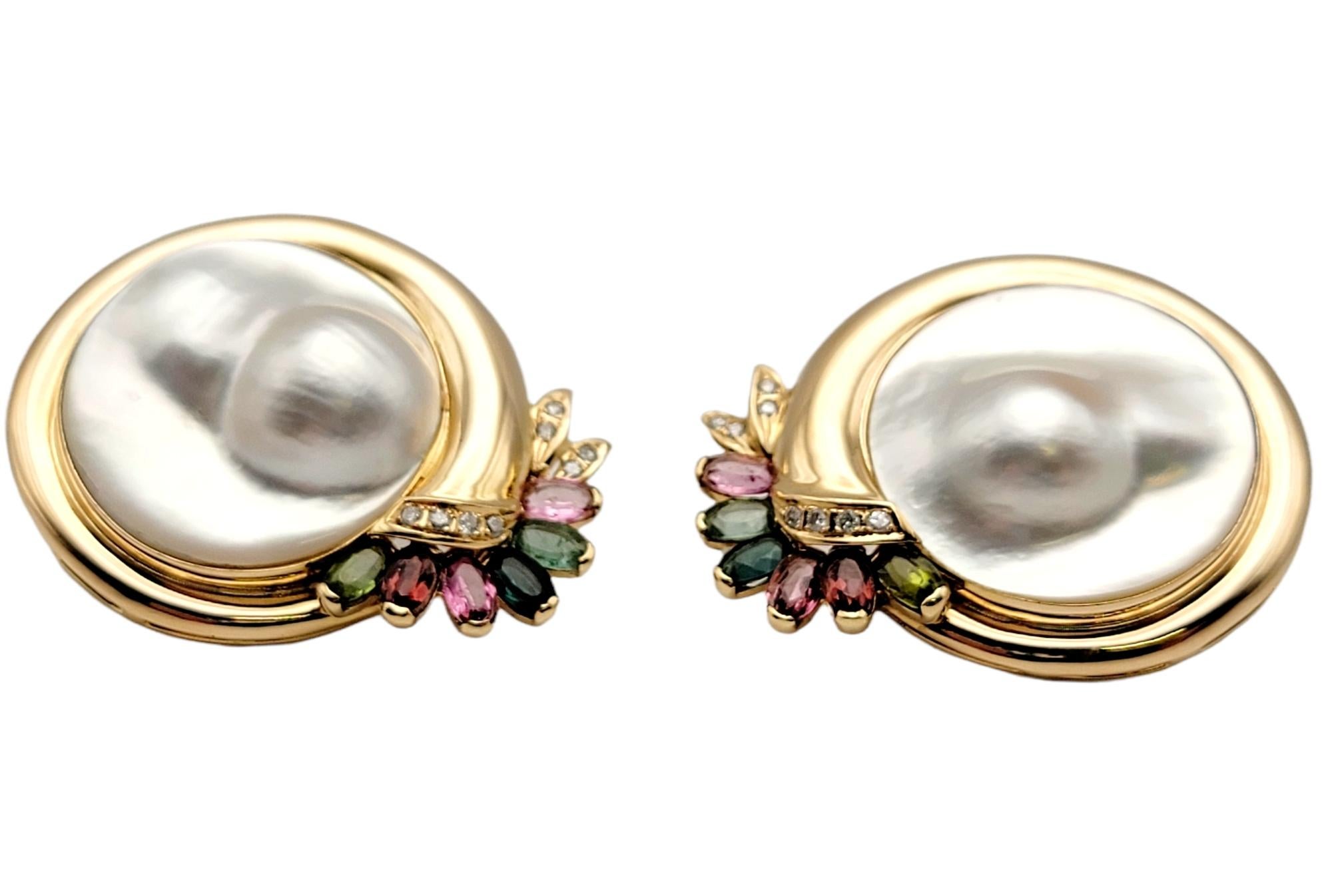 Absolutely beautiful pearl and gemstone pierced earrings fill the lobe with chic sophistication. Bold in both size and design, these elegant beauties feature stunning blistered Mabe pearl centers surrounded by polished yellow gold and accented with