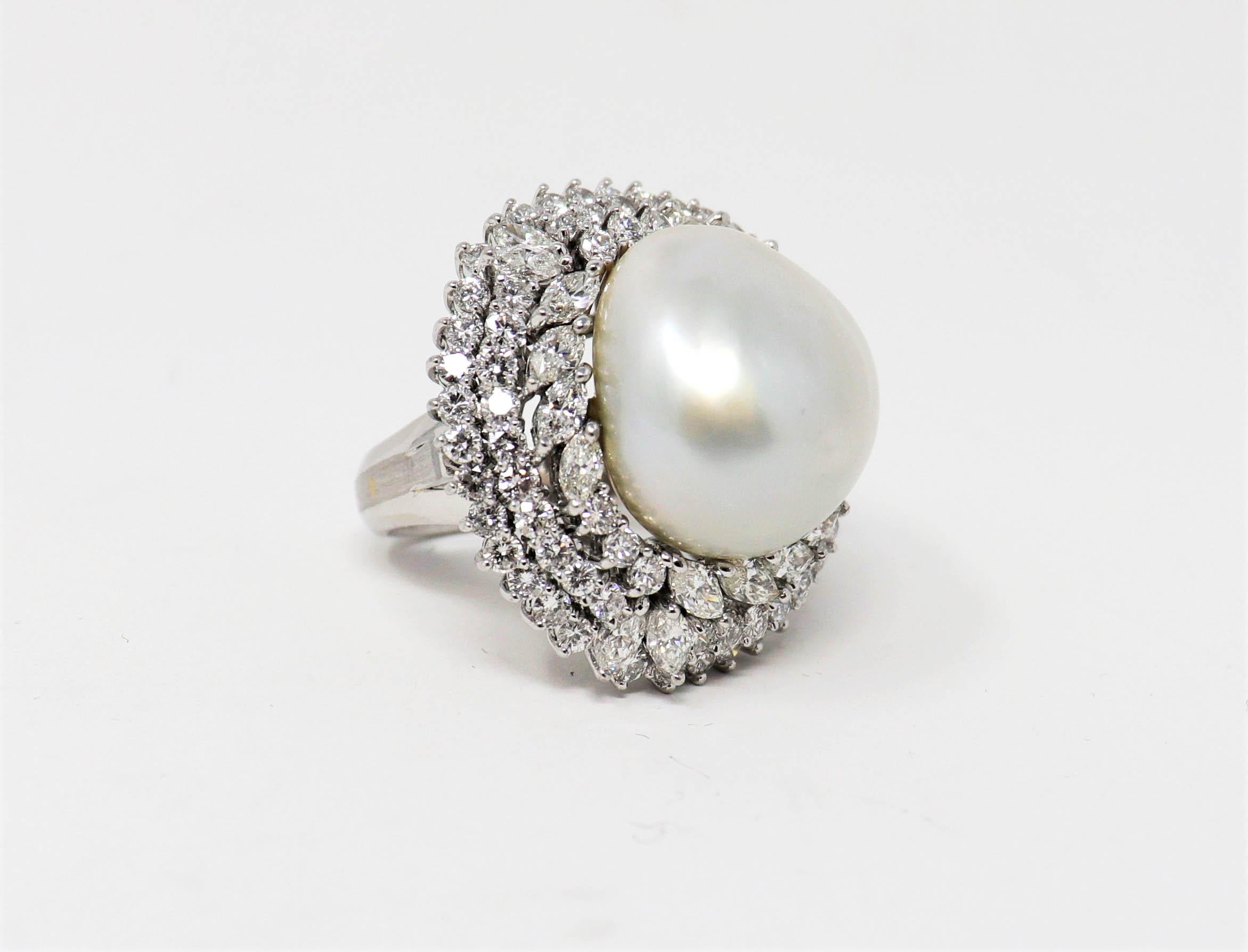 Ring size: 7.5

Breathtaking diamond and pearl ballerina cocktail ring with incredible fine details. Shimmering diamonds are set in a triple halo design and surround a large round mabe pearl, creating a bright and sparkling signature piece. 

This