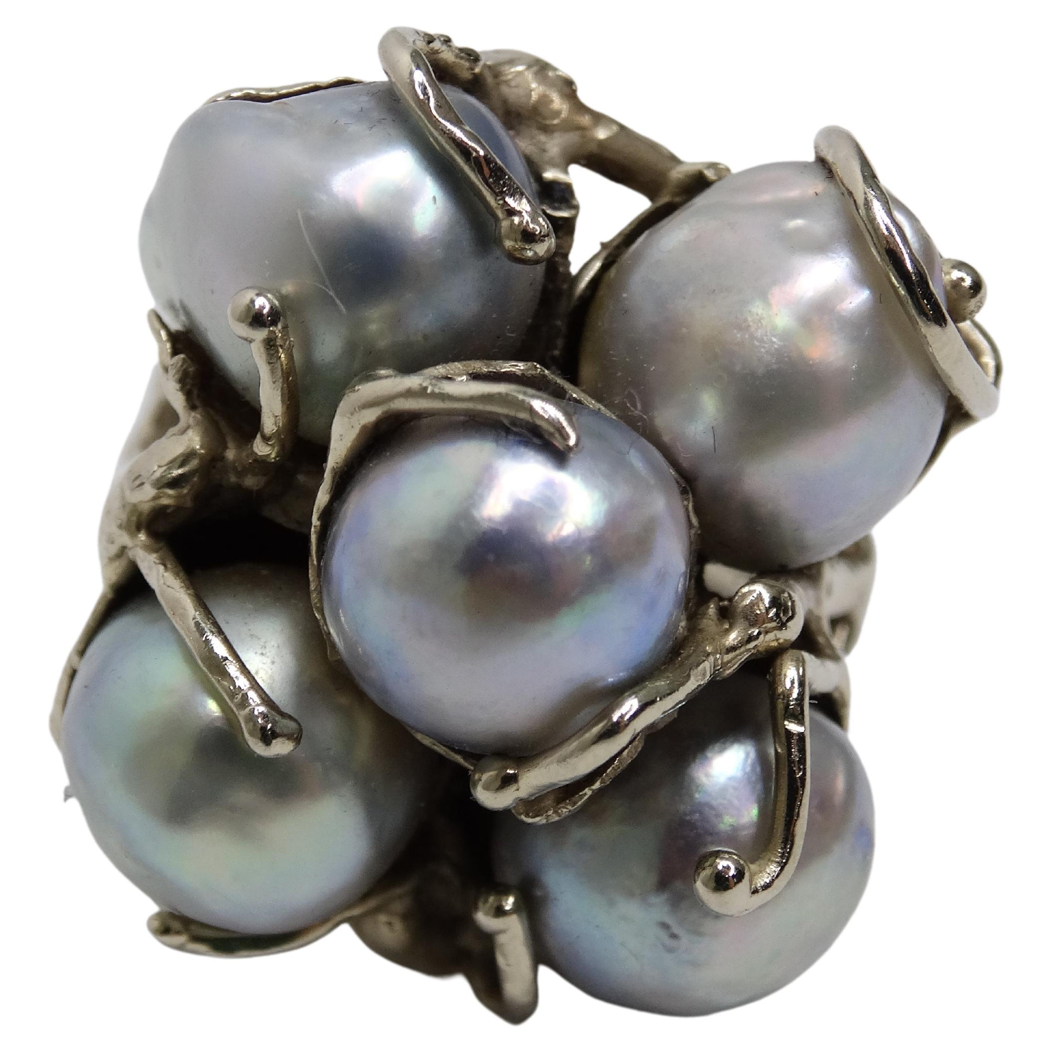 Decorate your hands with this beautifully made ring. Bring this 1970's ring back to life and add it to your jewelry collection. This cocktail ring is made to be shown off as it is large in size. This ring is made out of five large blue pearls that