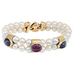 Cultured Pearl (6.5 x 7mm) bracelet with cabochon ruby and sapphire in 18K gold