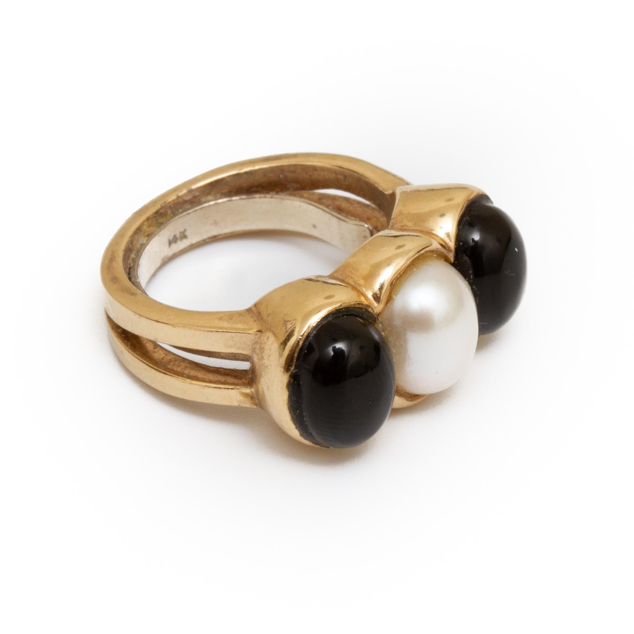 14k gold ring cabochon pearl set between two cabochon set black onyx approx. size 6 From the Broussard estate noted jewelry collection Park Avenue New York