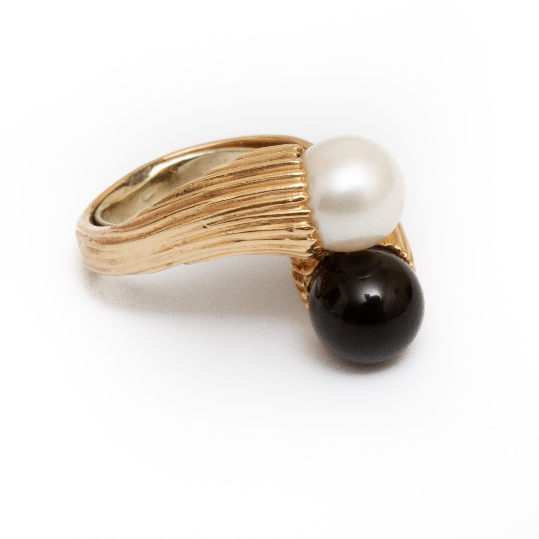 18k gold bypass ring with pearl and black onyx. Size 6.5 approx From the Broussard estate noted jewelry collection Park Avenue New York