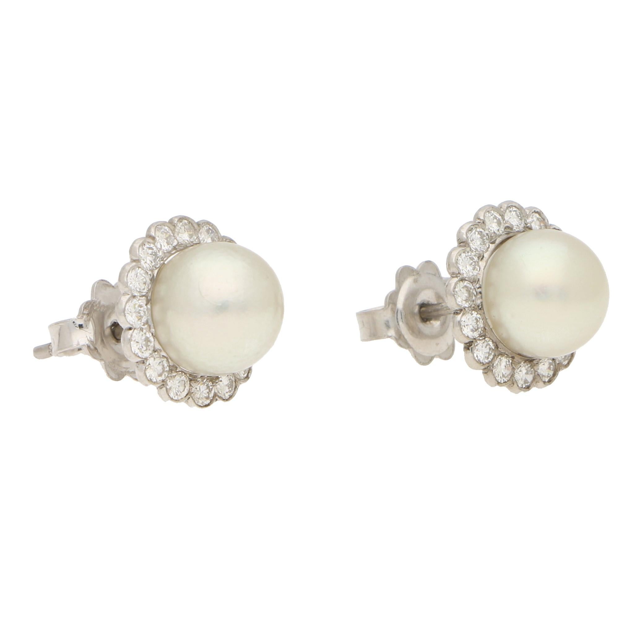 A beautiful little pair of cultured pearl and diamond cluster stud earrings set in 18k white gold. Each earring is centrally set with a lovely 6mm cultured pearl surrounded by 16 sparkly round brilliant cut diamonds. 

The earrings measure exactly