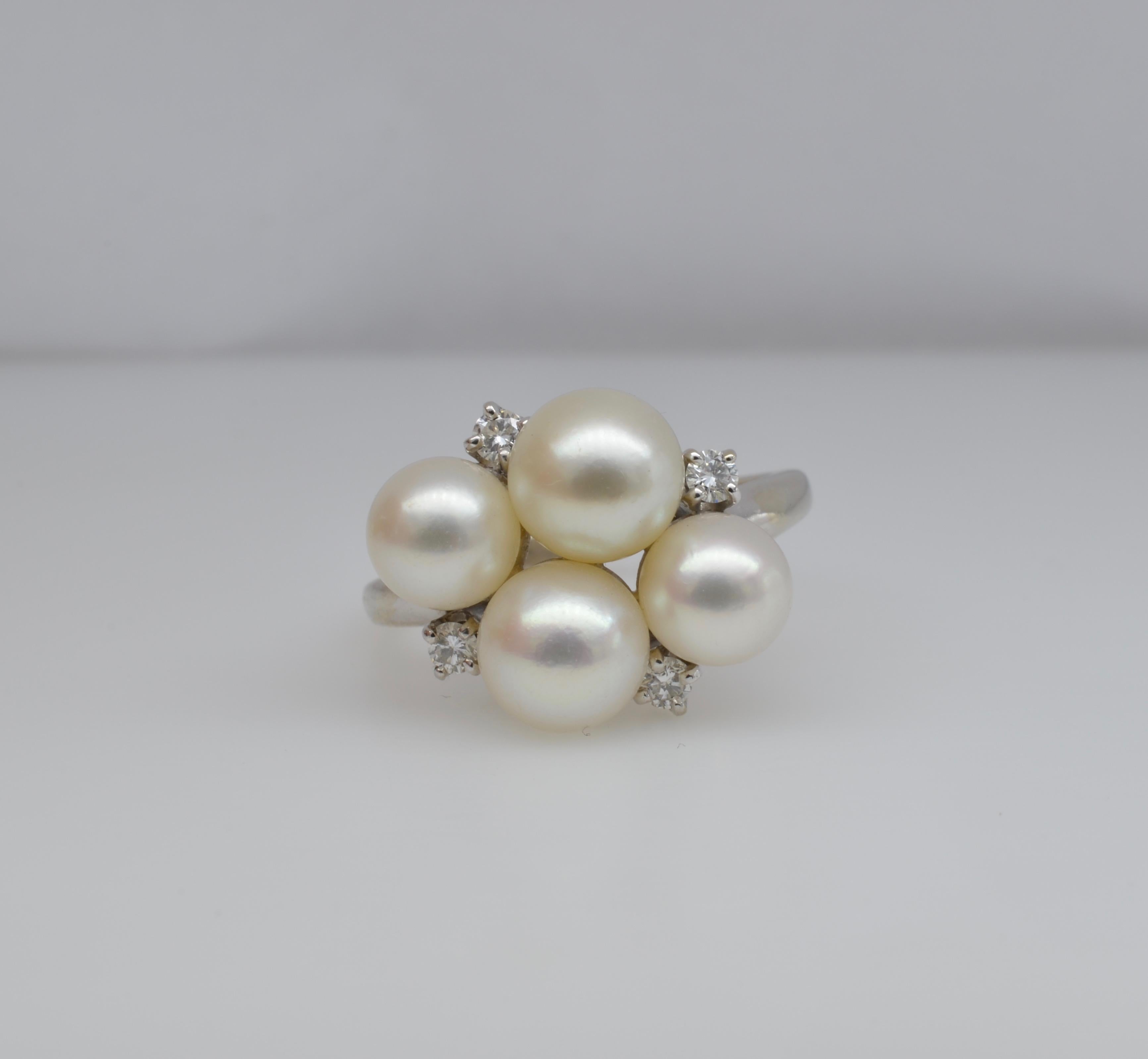 This beautiful Pearl and diamond ring is lovely and sweet. The combination of white 14k gold and the white cultured pearls accented with four diamonds (0.15 TW)  is perfect for any wardrobe. The size is 7 1/4 and can be sized to fit... In the
