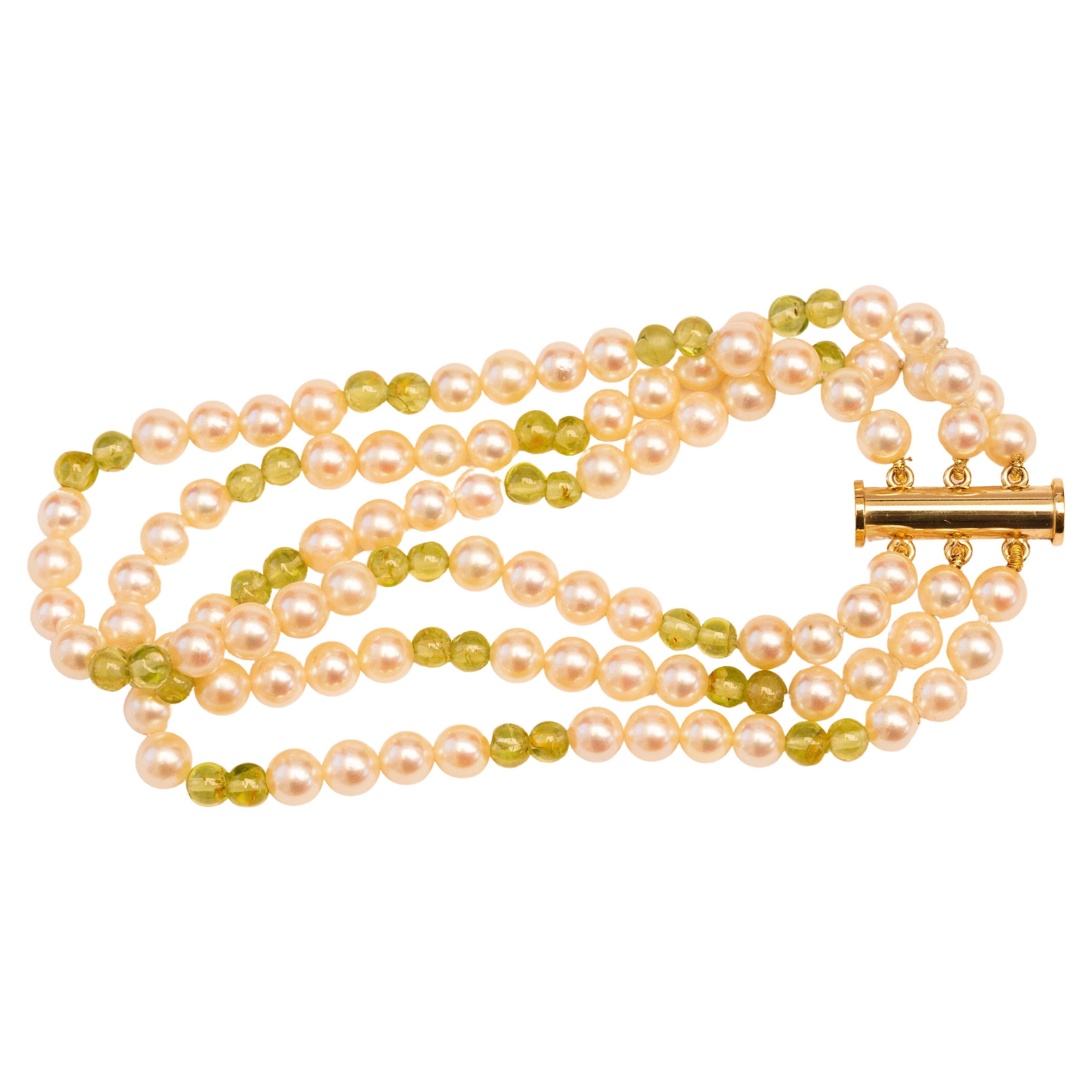 Cultured Pearl and Peridot Triple Strand Bracelet with 14 Karat Gold Closure For Sale