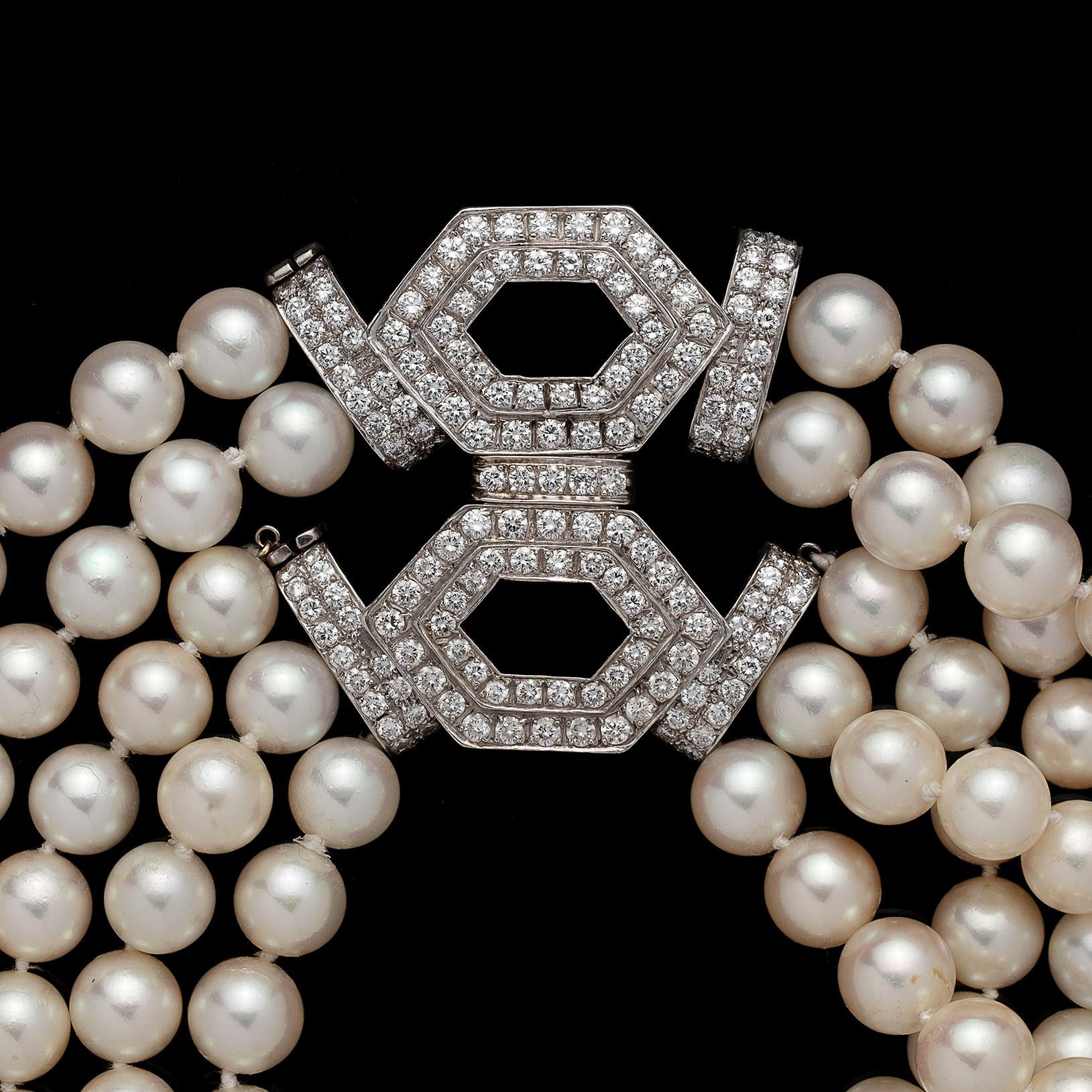 A stunning necklace that is convertible! Designed with 5 strands of 8.5mm cultured pearls, high luster with rose tones, completed by a round brilliant-cut diamond set geometric design clasp totaling 5.55 carats. The necklace can also be separated