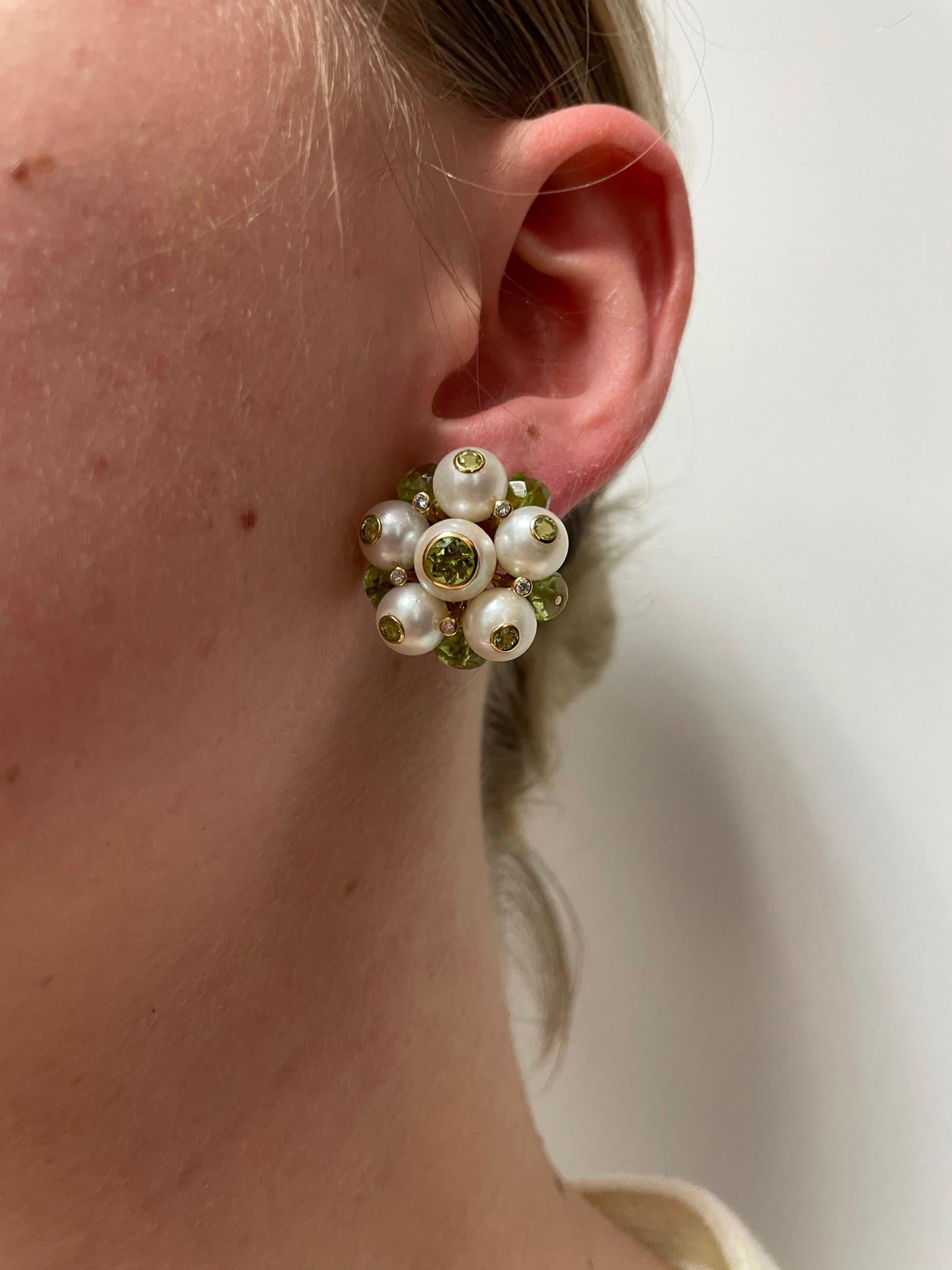 A pair of Cultured Pearl, Diamond, and Peridot Earrings, made in 18k Gold by Trianon. The earrings measure 1 inch x 1 inch. The diamonds weigh approximately 0.20 carats. 