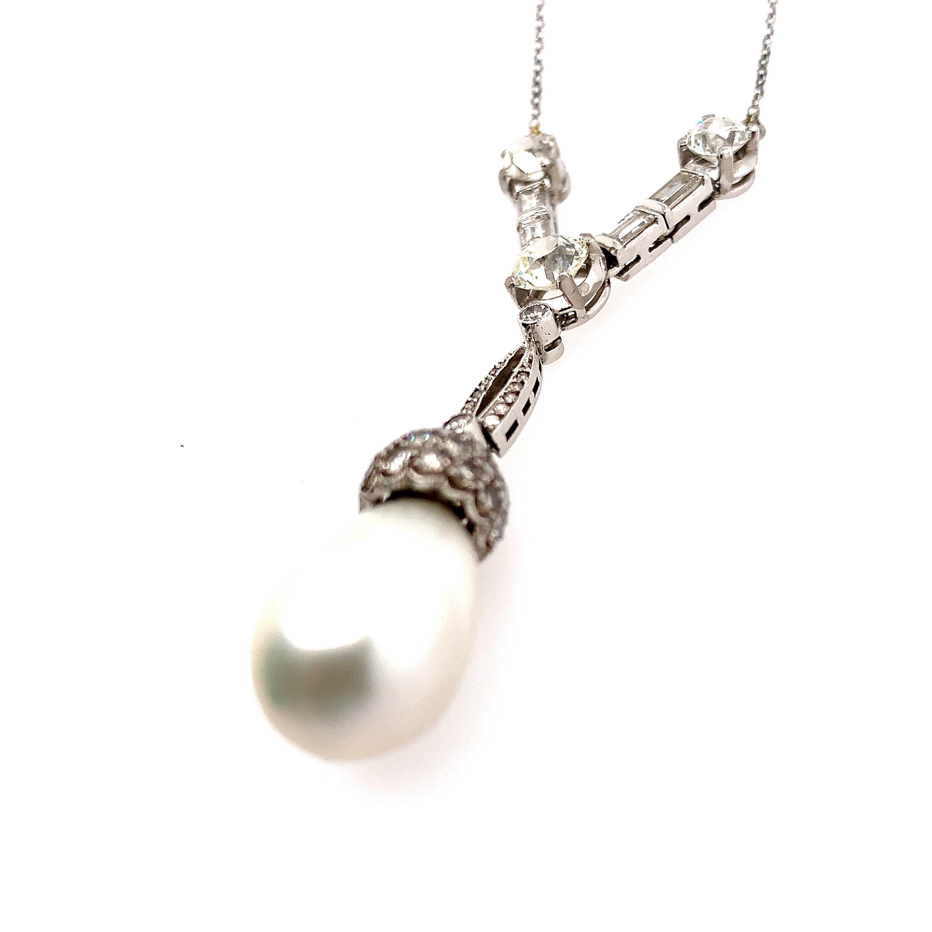 Suspending a cultured pearl drop measuring 10.6 mm by 14.0 mm, from a pavé-set diamond cap, further set with an old European-cut diamond weighing approximately 0.65 carat, a pair of smaller old European-cut diamonds weighing approximately 0.75