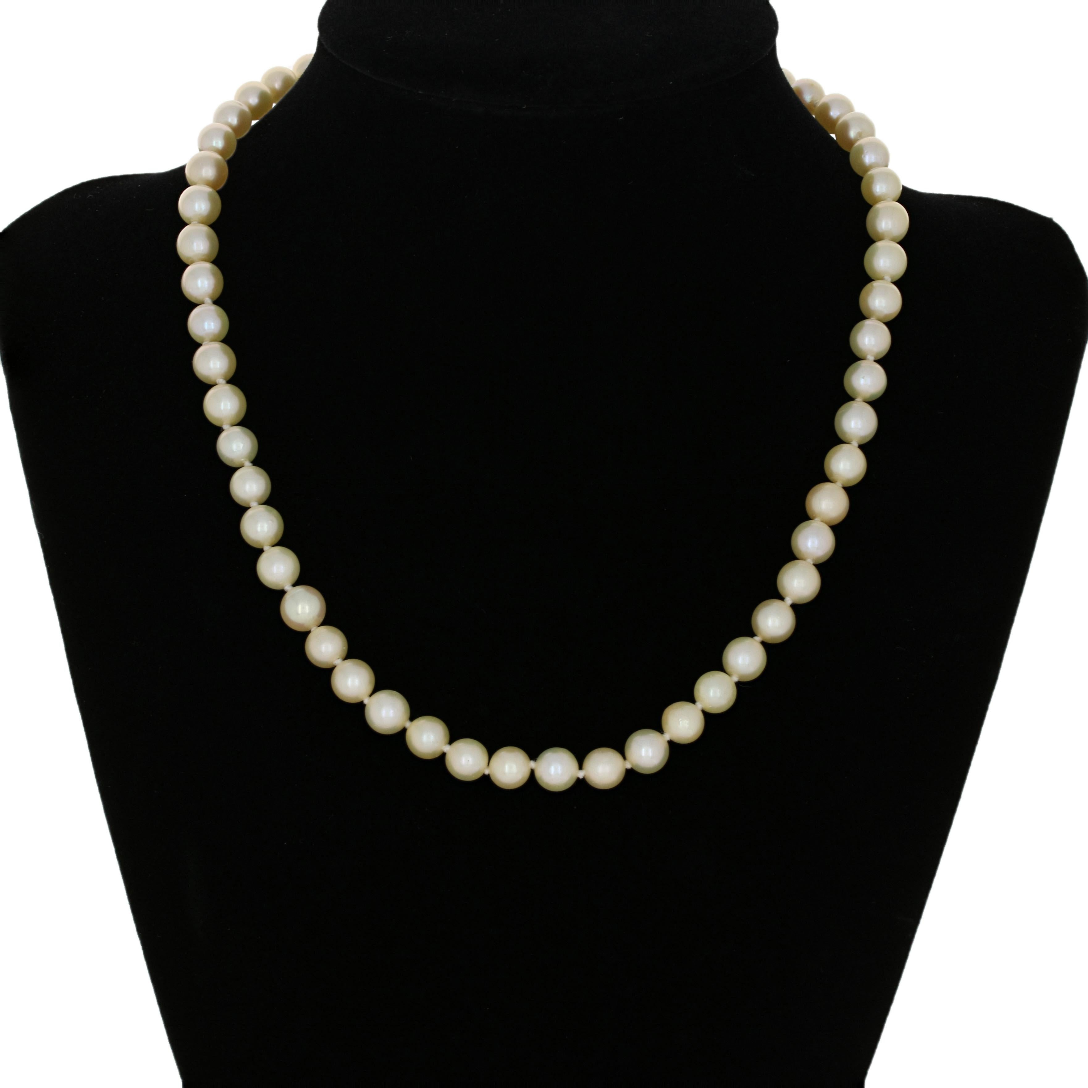 Timeless elegance defined! This necklace showcases luminous cultured pearls that have been freshly restrung on a durable knotted cord. Crafted in 18k white gold, the necklace's bow clasp is graced with a sparkling diamond and ornate milgrain work.  