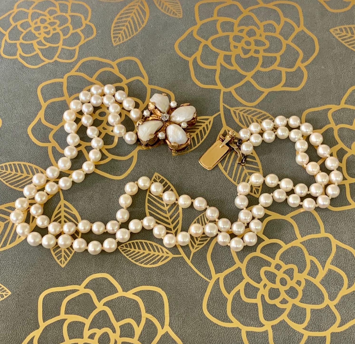 This double strand 6.5mm cream-colored cultured Pearl necklace features a custom made Pearl and Diamond clasp.  The Diamond is mine cut, 3.9mm in size and weighing approximately .25cts.  The clasp also features four Mississippi fan-shaped Pearls