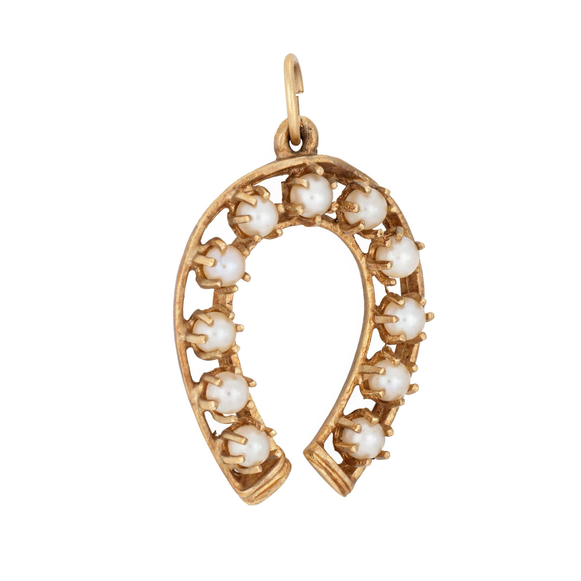 Finely detailed vintage cultured pearl horseshoe pendant crafted in 14k yellow gold (circa 1960s).  

Eleven cultured pearls measure approx. 3.5mm each. 

A symbol of good luck and protection, the sweet pendant can also be worn as a charm on a