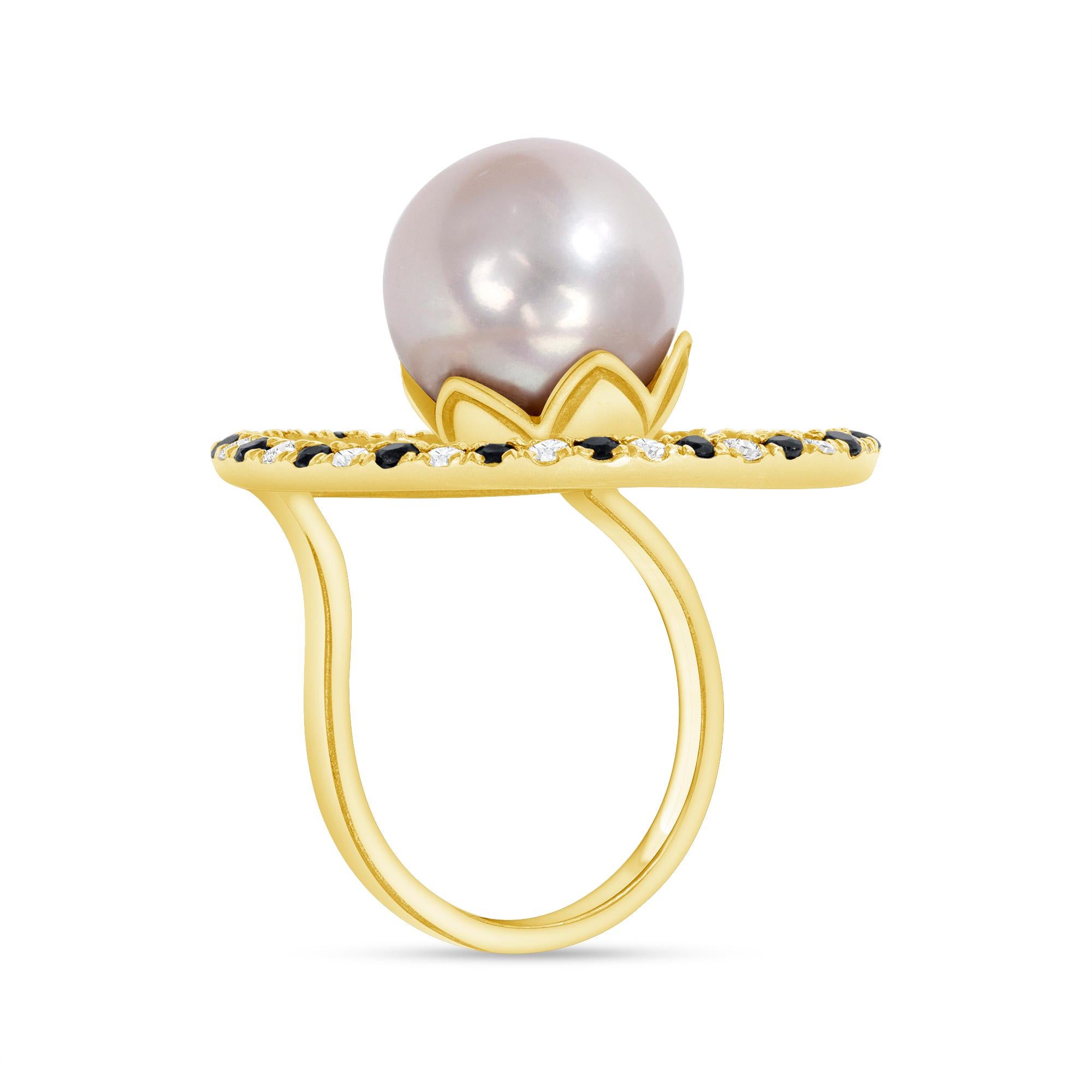 Designed by award-winning artist Brenda Smith, this size 7 to 7.5 cocktail ring is hand fabricated with 5.01 grams of 18-karat yellow gold. Surrounding the “floating” 13.26 millimeter cultured South Sea pearl is a ring of round-cut sapphires and