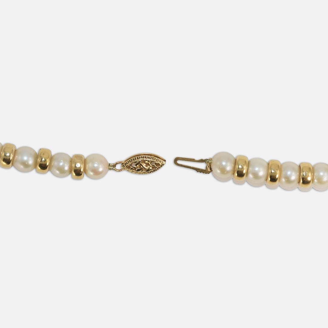 14k yellow gold and cultured pearl necklace.
The clasp is stamped 14k.
The gold spacers test 14k.
The gross weight of the necklace is 27.7 grams.
There are 64 hollow gold spacers, some have some dents.
The pearls measure 6mm to 6.4mm in diameter, in