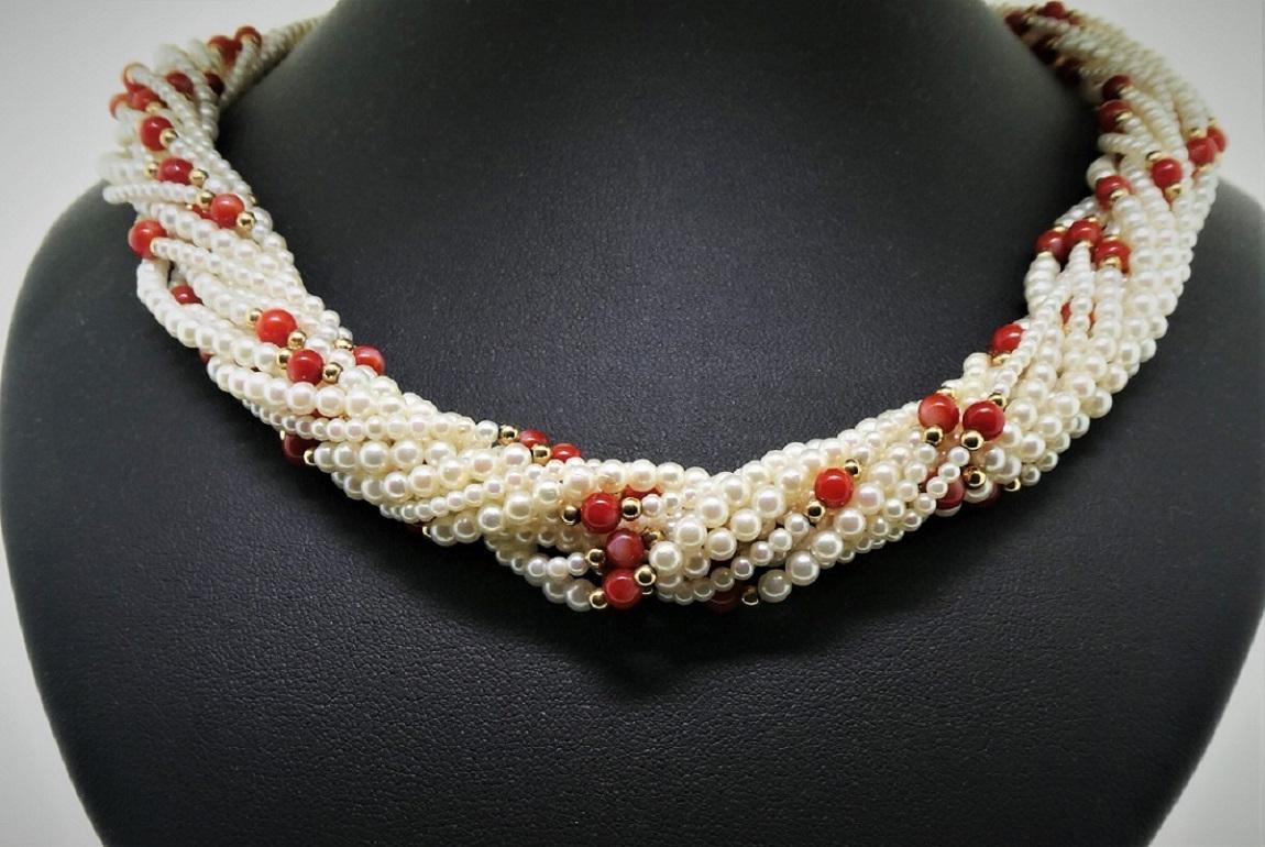 This necklace contains 12 strands of JAPANESE cultured peals, ranging in size from 2-4.5mm.  Mixed into the necklace there is one strand of fine oxblood coral beads that are 4-4.5mm.  On either side of the coral beads, there is a gold bead that