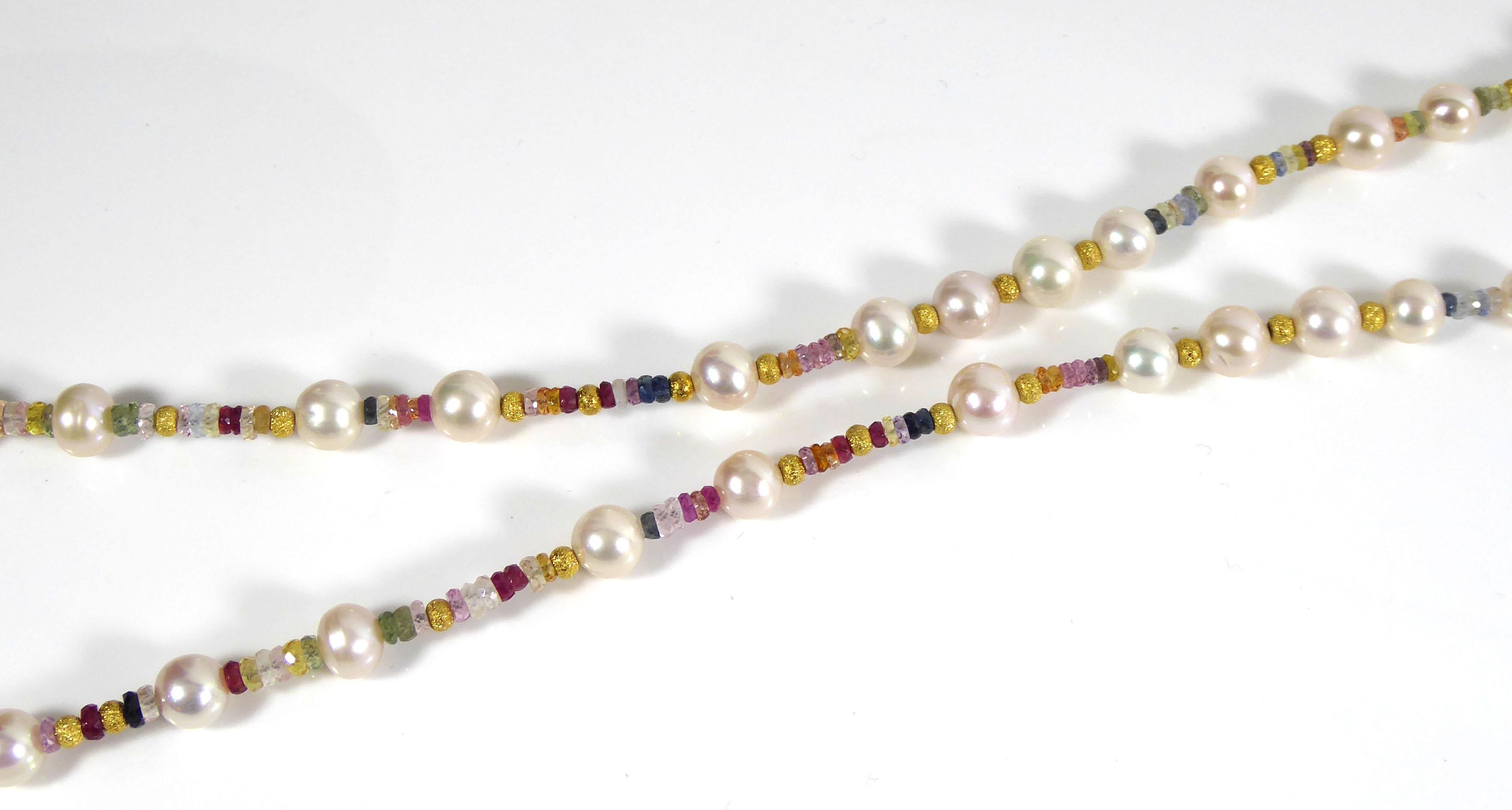Cultured pearls set with multi-coloured sapphire beads on silver wire, with silver gilt beads and clasp.
Stamped '925' (for sterling silver gilt) on tongue of clasp.
28ins/71cm