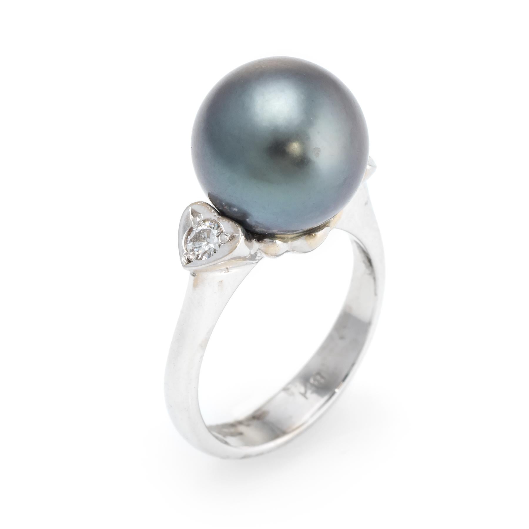 Elegant vintage cocktail ring, crafted in 18 karat white gold. 

Centrally mounted cultured Tahitian South Sea black pearl measures 11mm, accented with an estimated 0.10 carats of diamonds (estimated at I-J color and SI1 clarity). The pearl is in