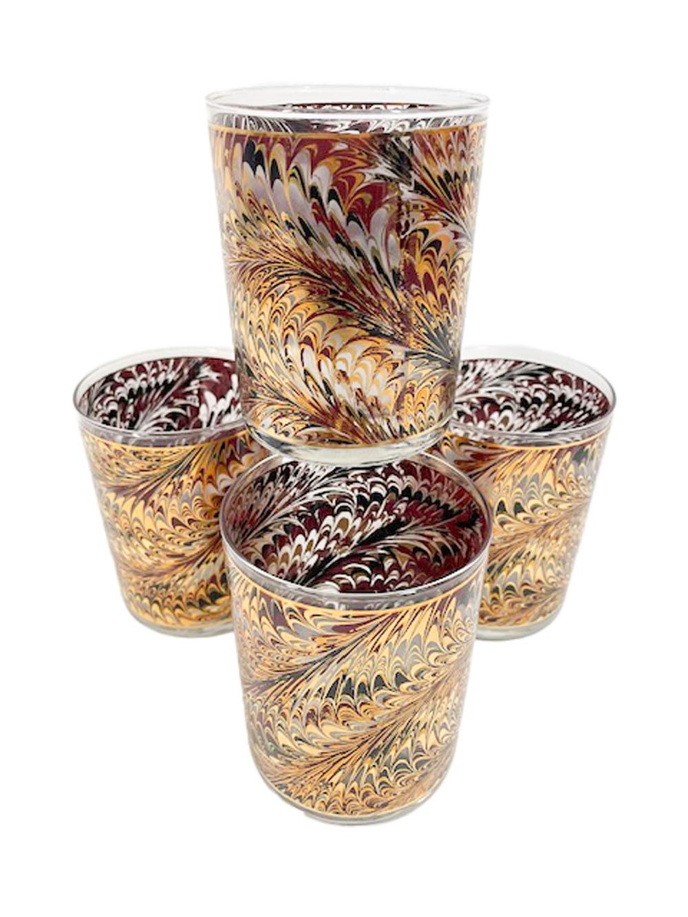 Set of four Culver, LTD rocks glasses decorated with 22k gold, enamels and frosted surface in a marbleized, endpaper pattern.