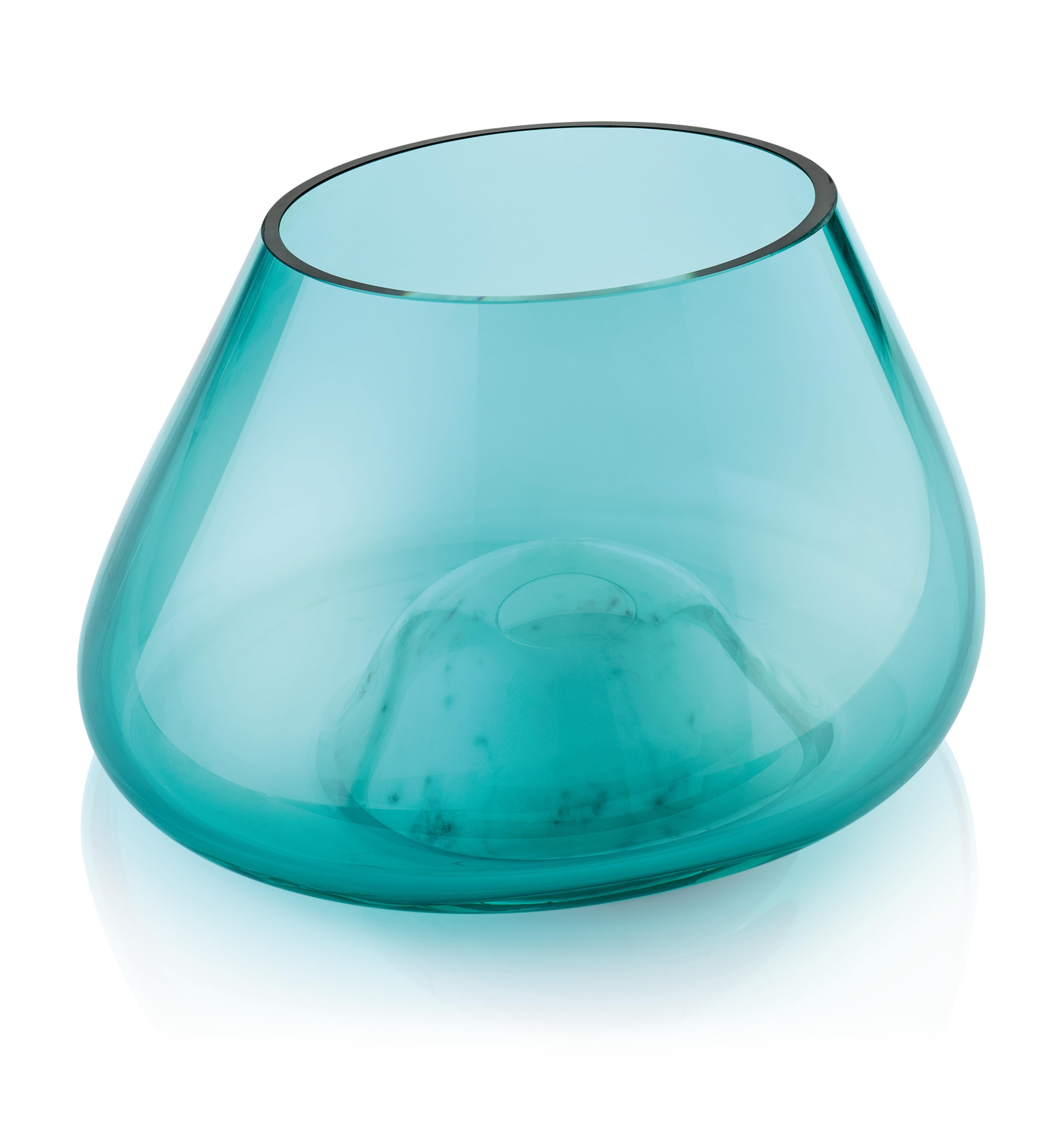 The Cumuli Blue Glass Vase collection is part of the collection in Basaltina stone or Carrara White marble and offhand glass defines changing landscapes. 
Inspired by Sicilian saline, it reminds of magical places, close to man s memory. Piles of