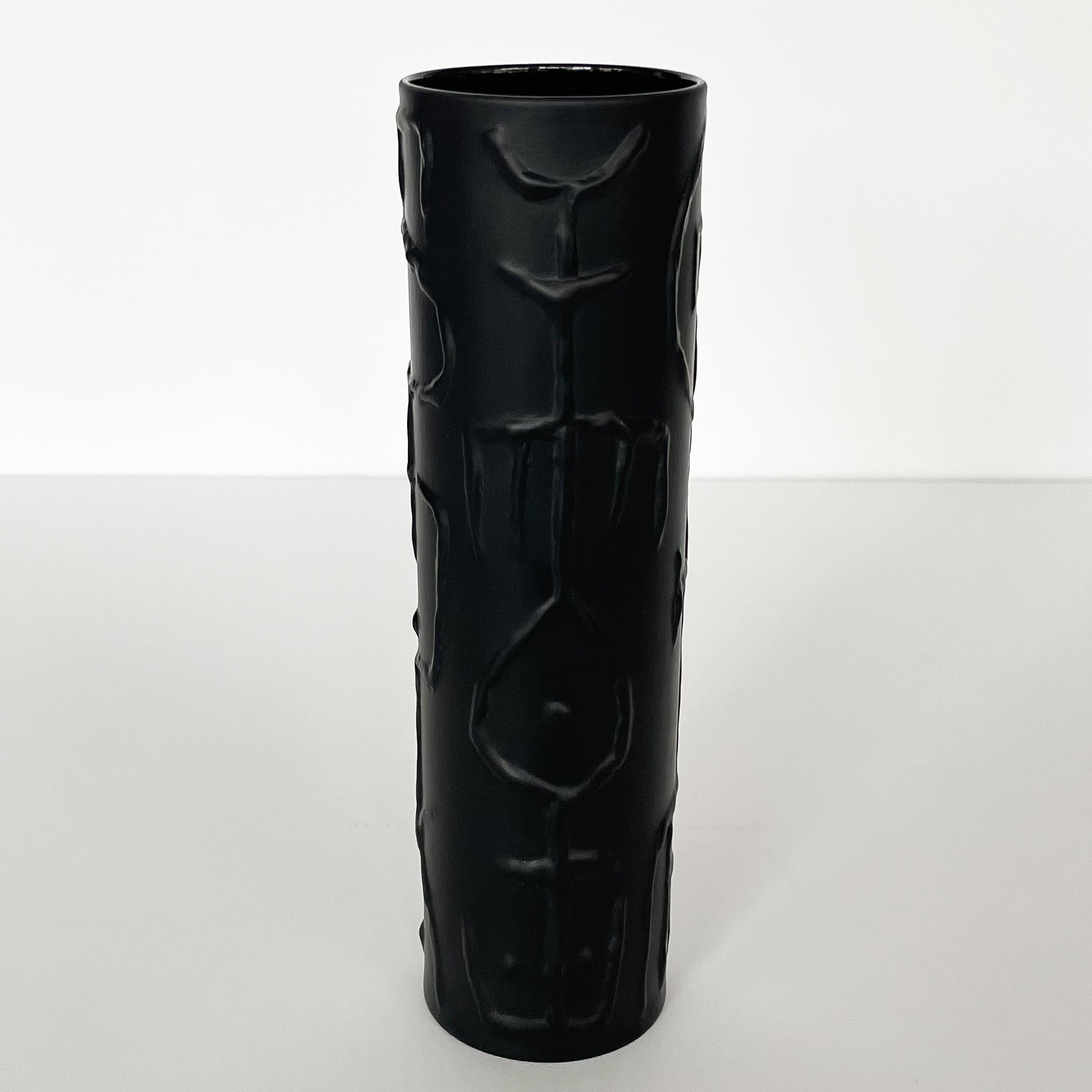Uncommon black matte abstract porcelain vase by Cuno Fischer for Rosenthal, Germany, circa 1970s. Black matte glazed porcelain cylinder with a graphic raised geometric tribal motif. Marked to the bottom with Rosenthal, Studio Line and the artist's