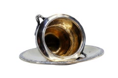 Cup and saucer in silver with spikes and raised handles