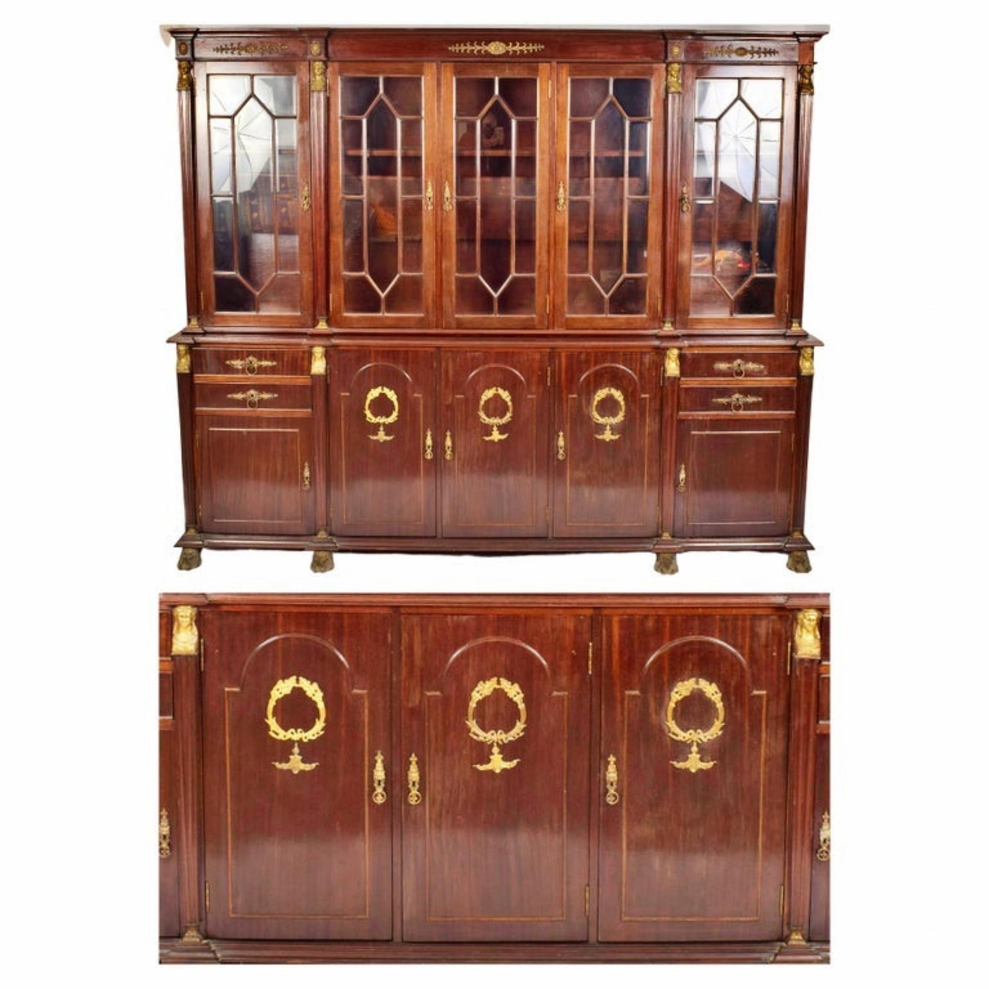 Cupboard
Empire taste 19/20th century, France.

Mahogany, mahogany veneer and other hardwoods.
Upper body with four glass doors and pediment cymbal, lower body with four drawers and five doors, decoration with gilt bronze applications