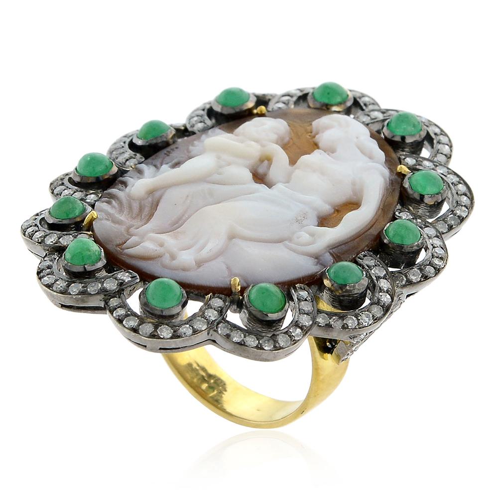 This lovely hand carved shell cameo ring with diamond and emerald scalloped design can be worn day to night.

Ring Size: & ( can be sized )

18k:3.18 g
Diamond: 1.24 cts
Slv: 7.16 gms
Emerald:1.5 cts
Cameo-11.55 cts