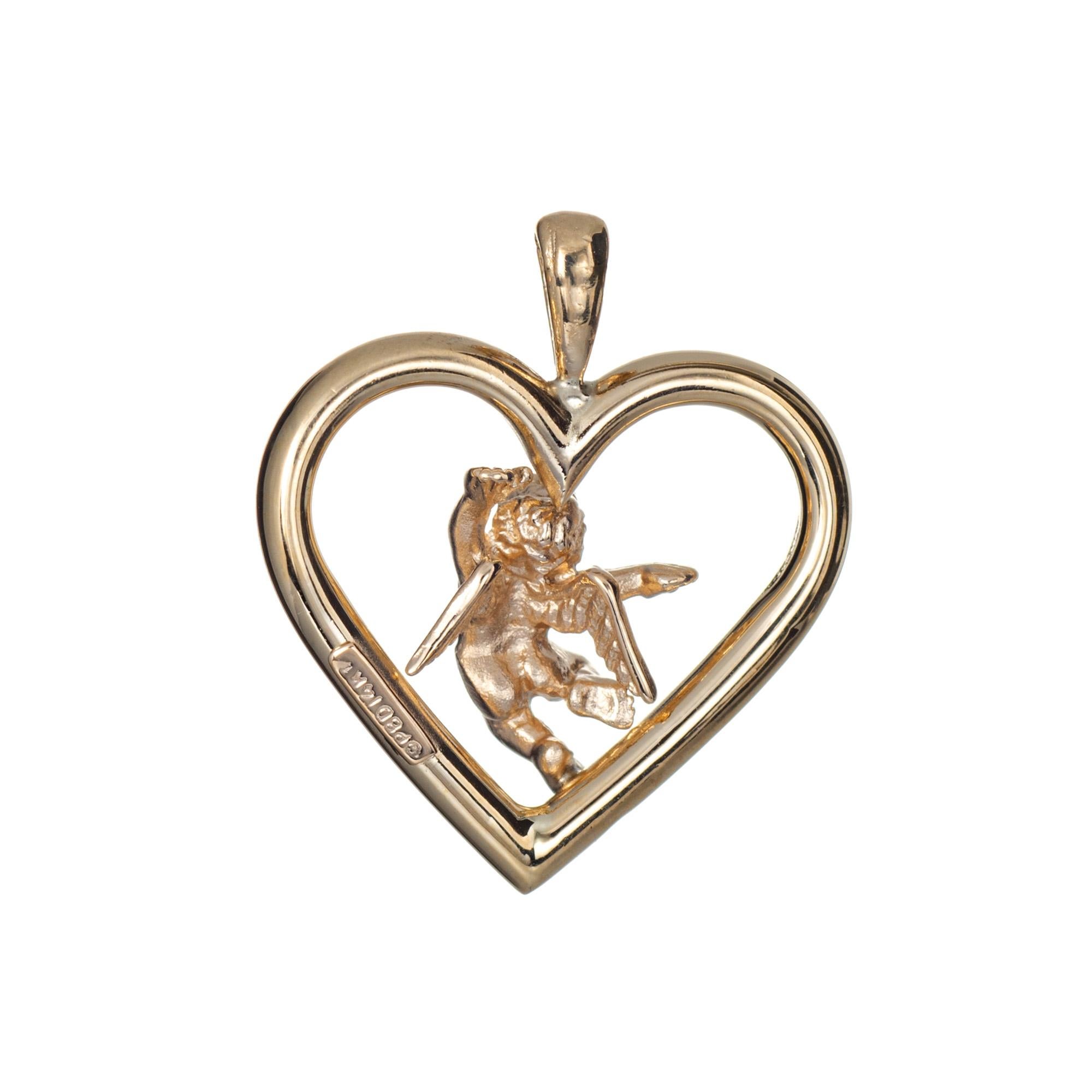 Finely detailed cupid angel heart pendant (or charm) crafted in 14k yellow gold.  

The nicely detailed pendant is small to medium in scale and features a winged cupid angel. The piece can be worn on a chain or as a charm on a bracelet. 

The