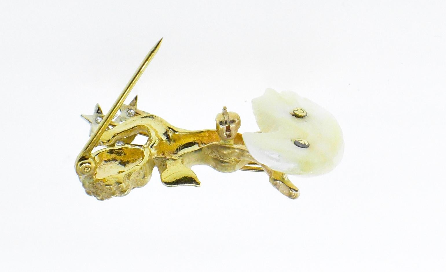 Angel delivering a bouquet of stars and standing on a baroque cultured pearl.  There are five diamonds accenting this charming piece which is 1.5 inches in length and weighing 9.19 grams.  In fine condition, this brooch was made mid 20th century.