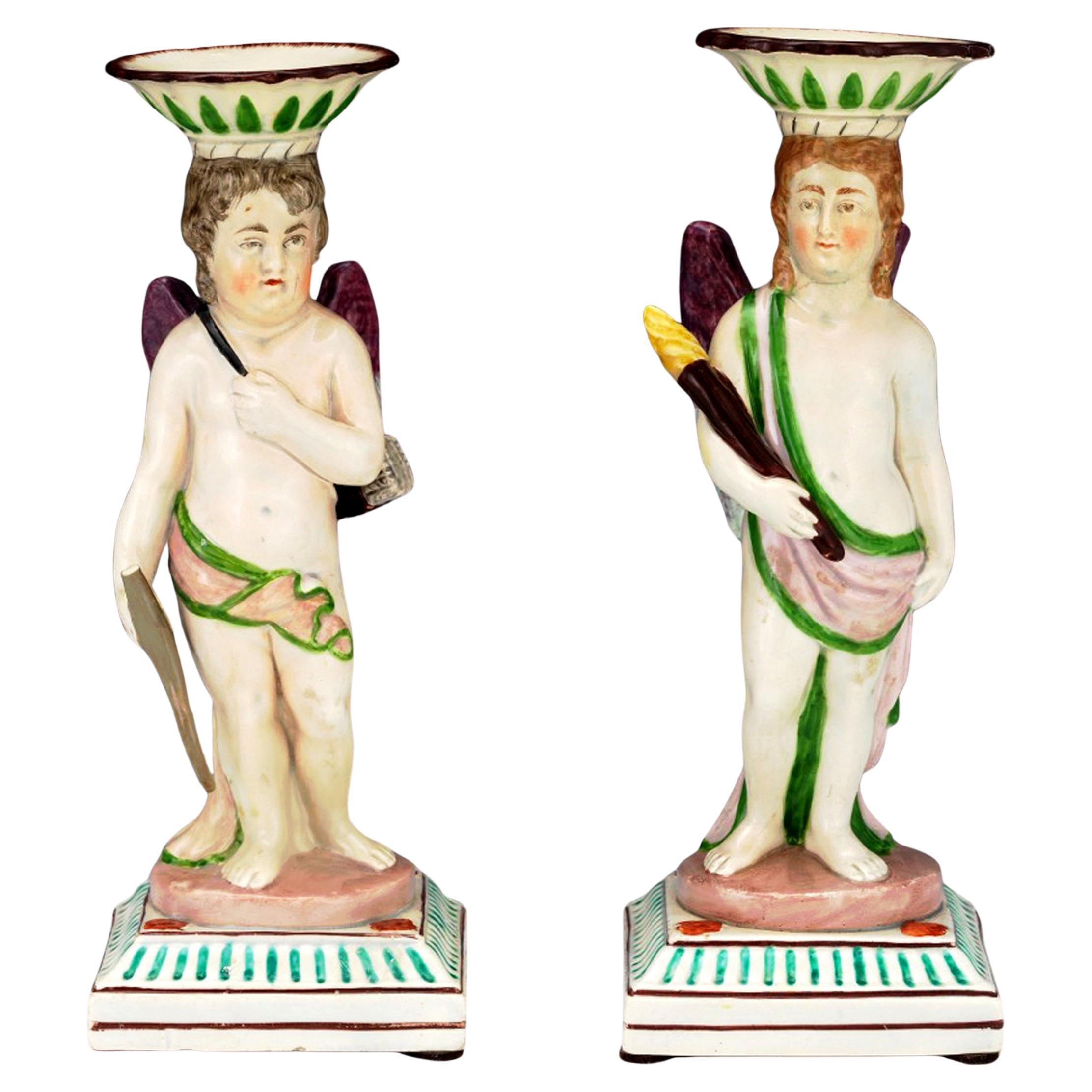 "Cupid 
The Torchbearer": Pair of Neale 
Co. Pearlware Figural Candlesticks en venta
