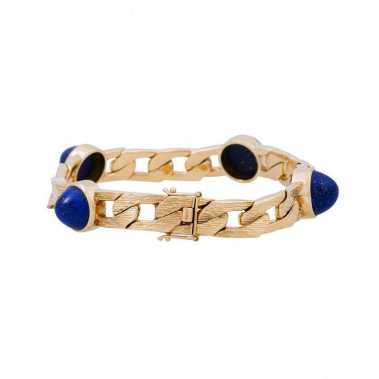 Cabochon cut total approx. 24 ct, GG 18K, bark engraved, 55 g, L: approx. 19 cm, W: approx. 1.2 cm, middle of the 20th century, slight signs of wear, box lock with 2x safety eight, solid Execution.

 Curb link bracelet with 4 lapis lazuli cabochon