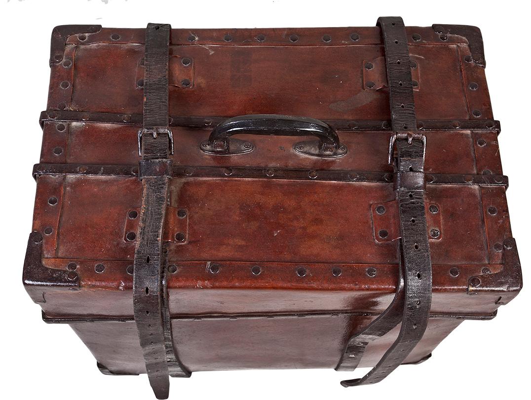 A cured leather steamer luggage trunk from the early 1900s. This could make a great coffee or side table by adding glass with clear risers, Colonial British.