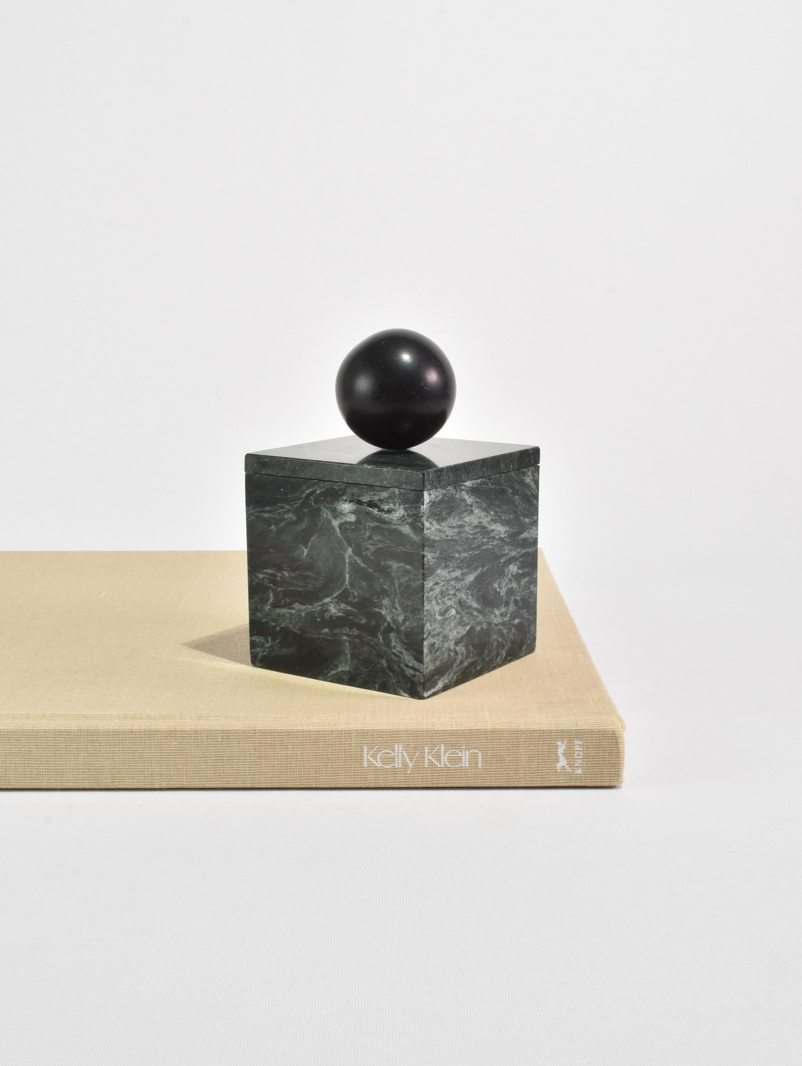 The Curio Box by Casa Shop in Green Marble with Black Onyx. Inspired by a favorite vintage find, each box features a square base with a sphere handle. Handmade by artisans in India.

Use it to hide away an array of items – a rare collection of