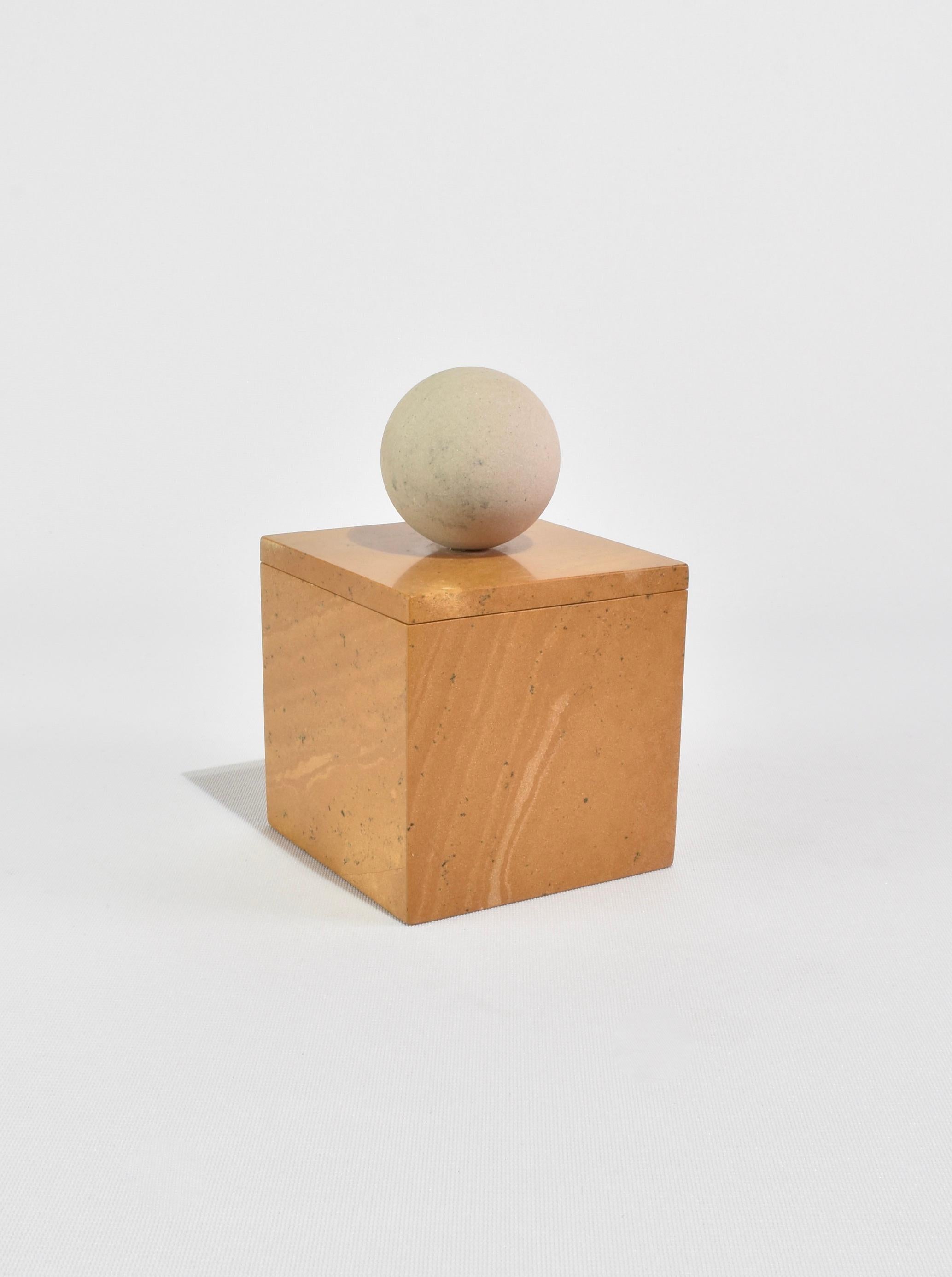 The Curio Box by Casa Shop in Yellow Jaisalmer with Beige Sandstone. Inspired by a favorite vintage find, each box features a square base with a sphere handle. Handmade by artisans in India.

Use it to hide away an array of items – a rare collection