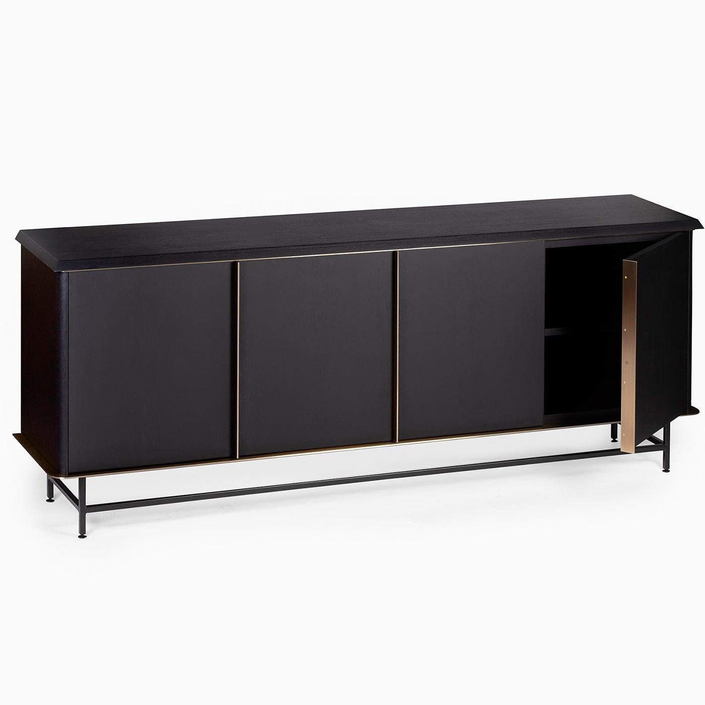 Clean, essential lines define this minimalist sideboard of Nordic inspiration. Boasting a four-door profile, it is handcrafted of black-lacquered ash and features a linear lacquered iron base. The doors are enriched with burnished brass-finished