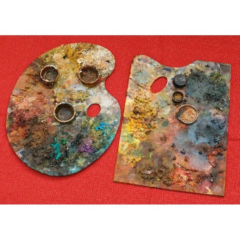 Collection of wood painter's palettes from France, circa 1940. Thick textured paint with beautiful colors. Two of the palettes have mixing cups attached with layers of paint. Sizes vary slightly. Measurement listed is an average. Kidney shaped