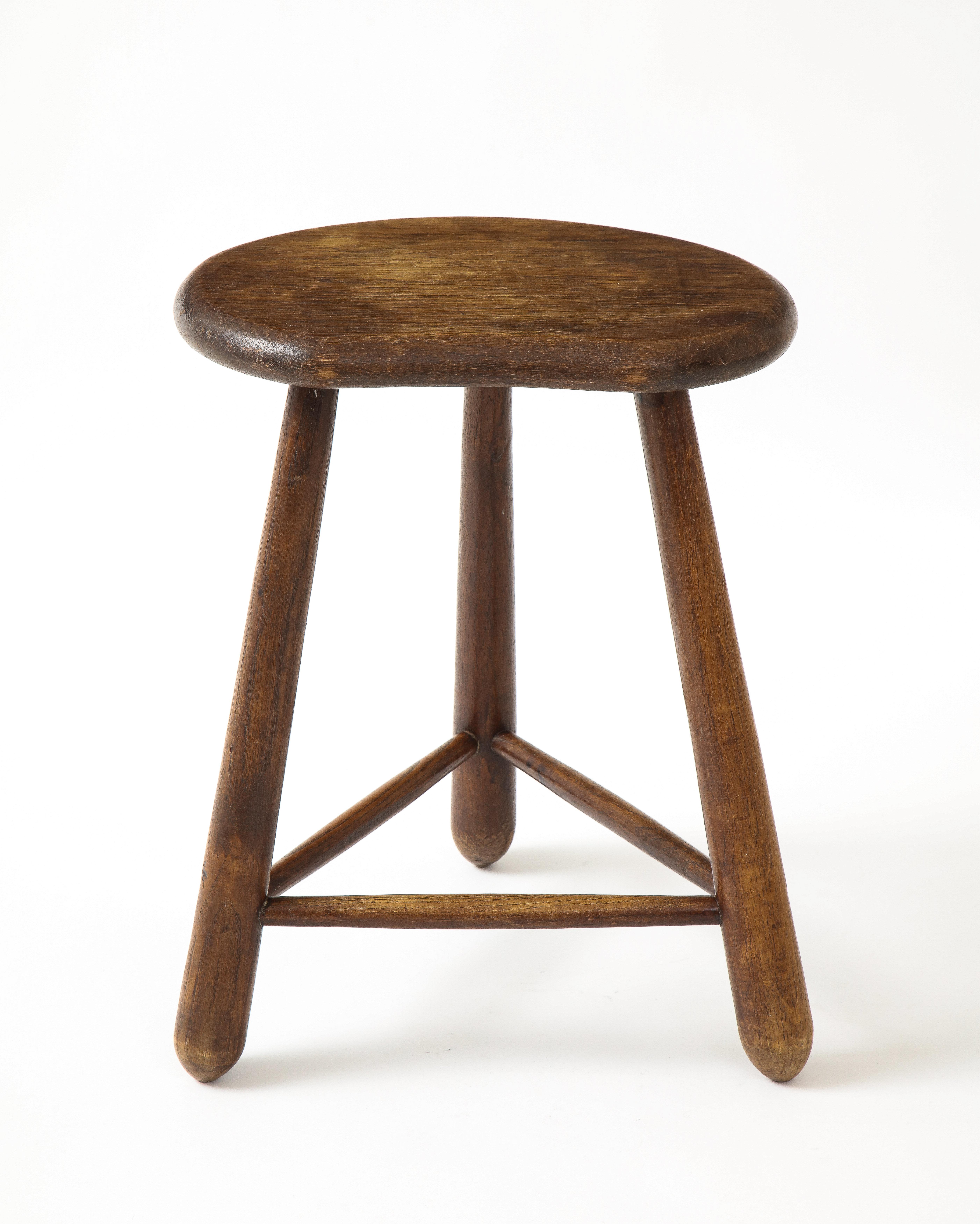 French oak stool with a curiously formed seat and support structure. Wonderful patina. Beautifully rounded edges. Hand-made.